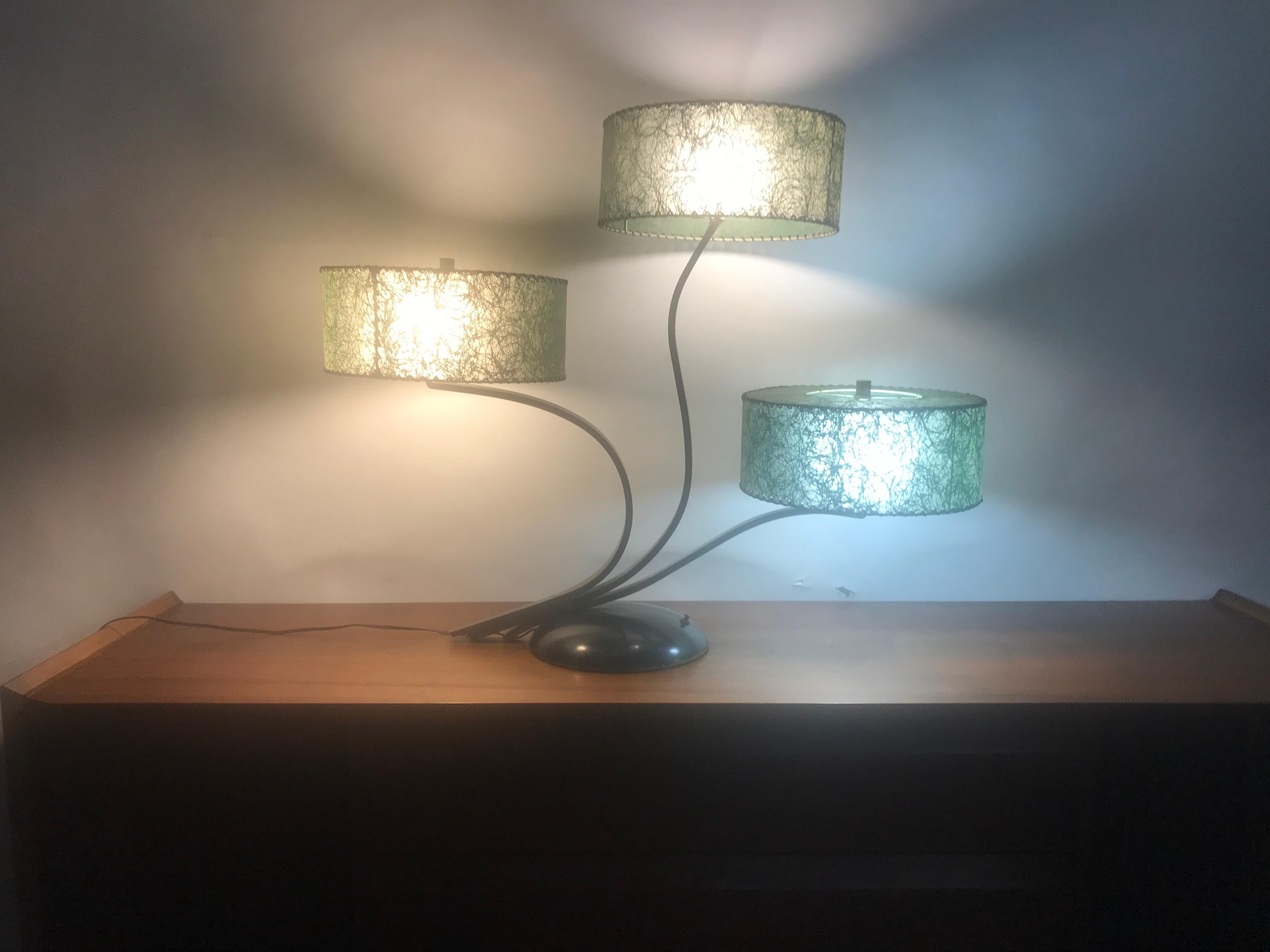Unusual triple shade table lamp, Majestic Lamp Company, green fiberglass shades, Classic Mid-Century Modern design. Three way light capability, retains 3 original fiberglass lamp shades. Amazing design. Truly a piece of art, sculpture.