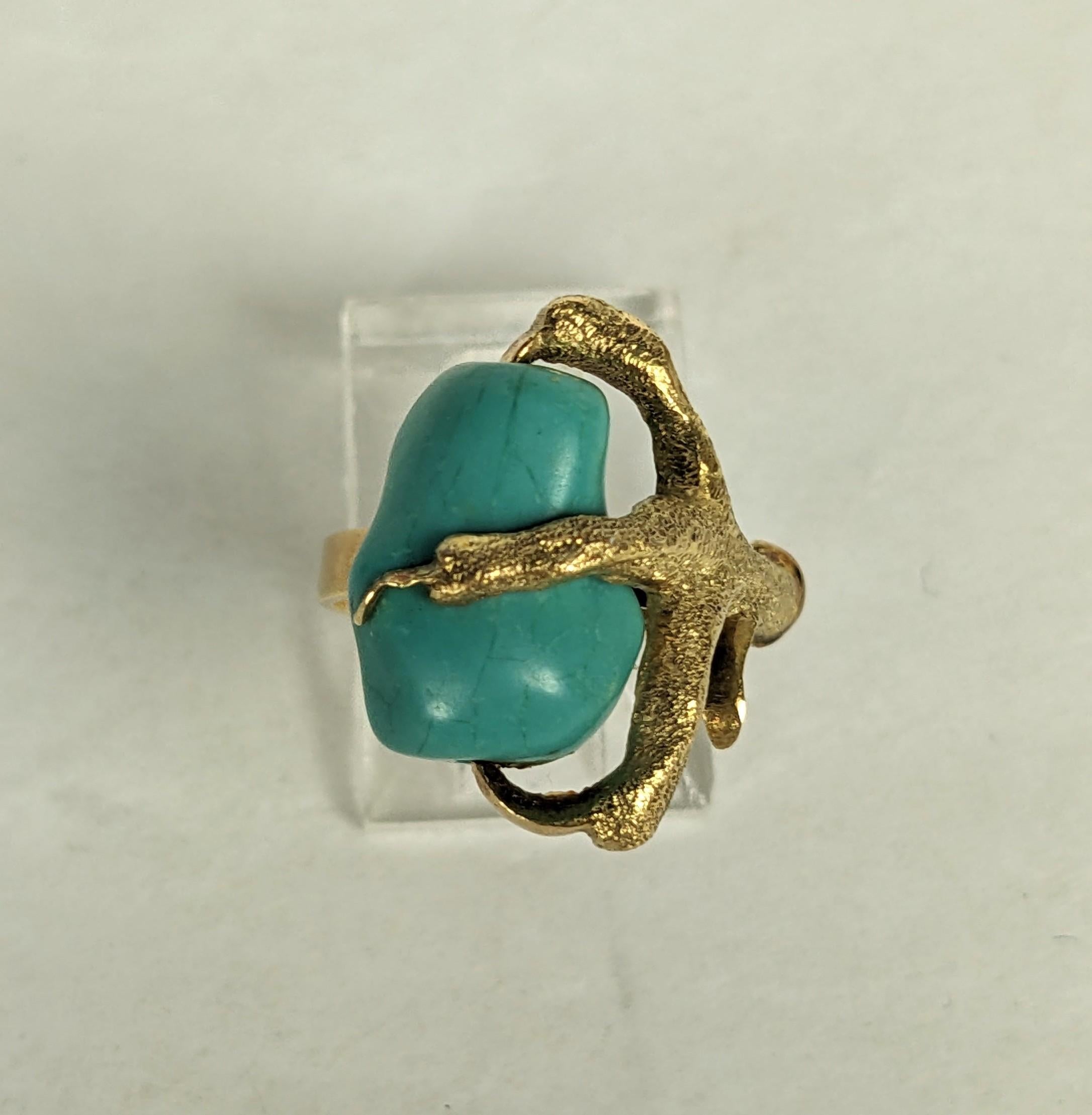 Cool Tumbled Turquoise Claw Ring in 14k from the 1960's. A viscious claw in stippled gold holds a tumbled turquoise nugget with high polished claws, very unusual and a great stackable. 
Size 5, Marked 14k. 1960's USA. 