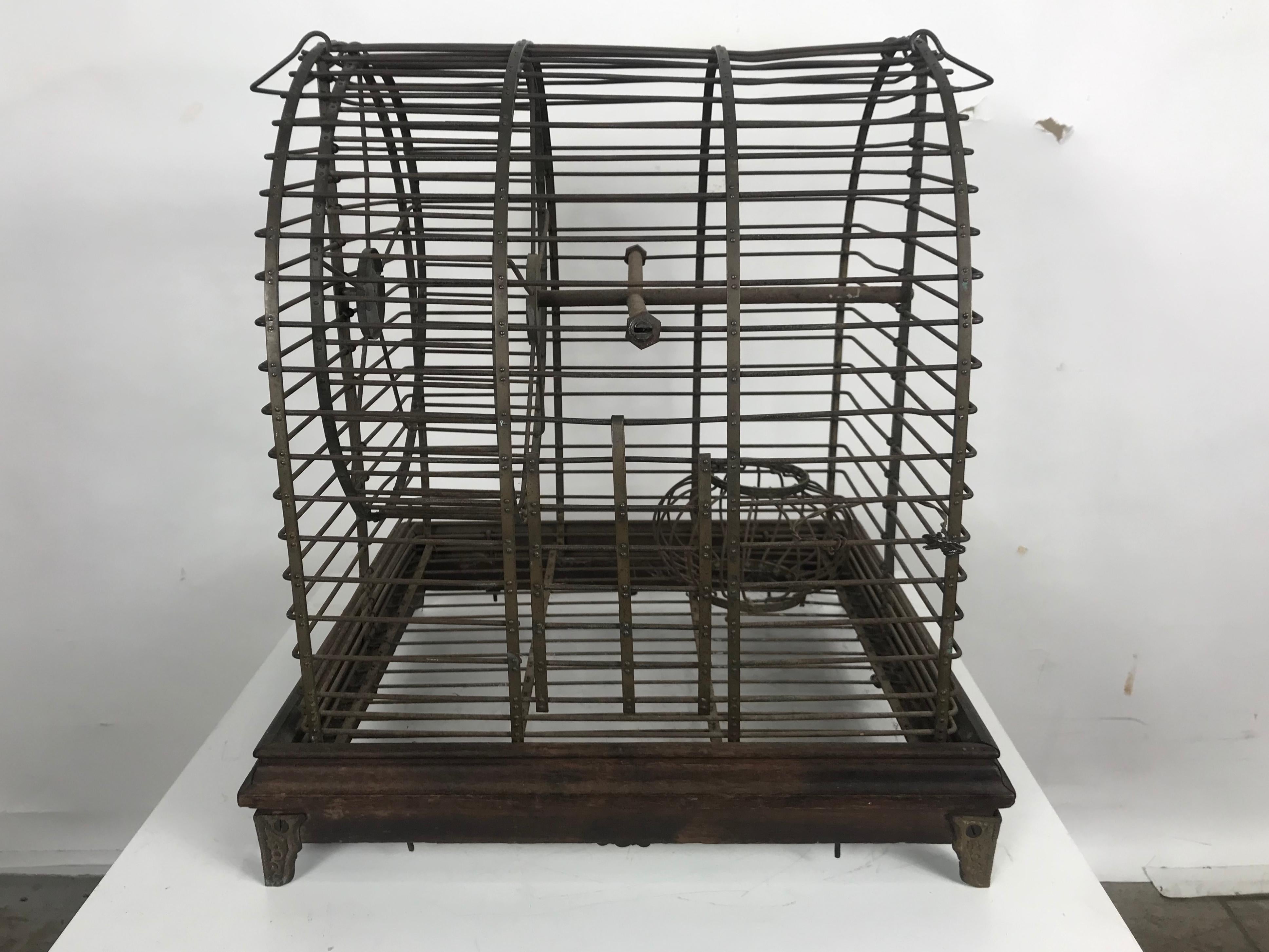 Unusual turn of the century industrial brass small animal cage with wheel. Possibly made by Pierce Arrow. Buffalo NY. Superior quality and construction. Smooth spinning hamster wheel, charming little decorative item.