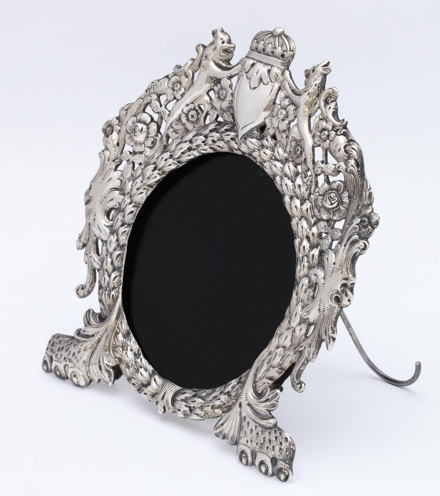 Unusual, Victorian, all sterling silver, lion's paw - footed picture frame decorated with mythological figures and having an all sterling silver easel. Made in New York by Udall and Ballou, circa 1900. Vacant cartouche. Frame has its original