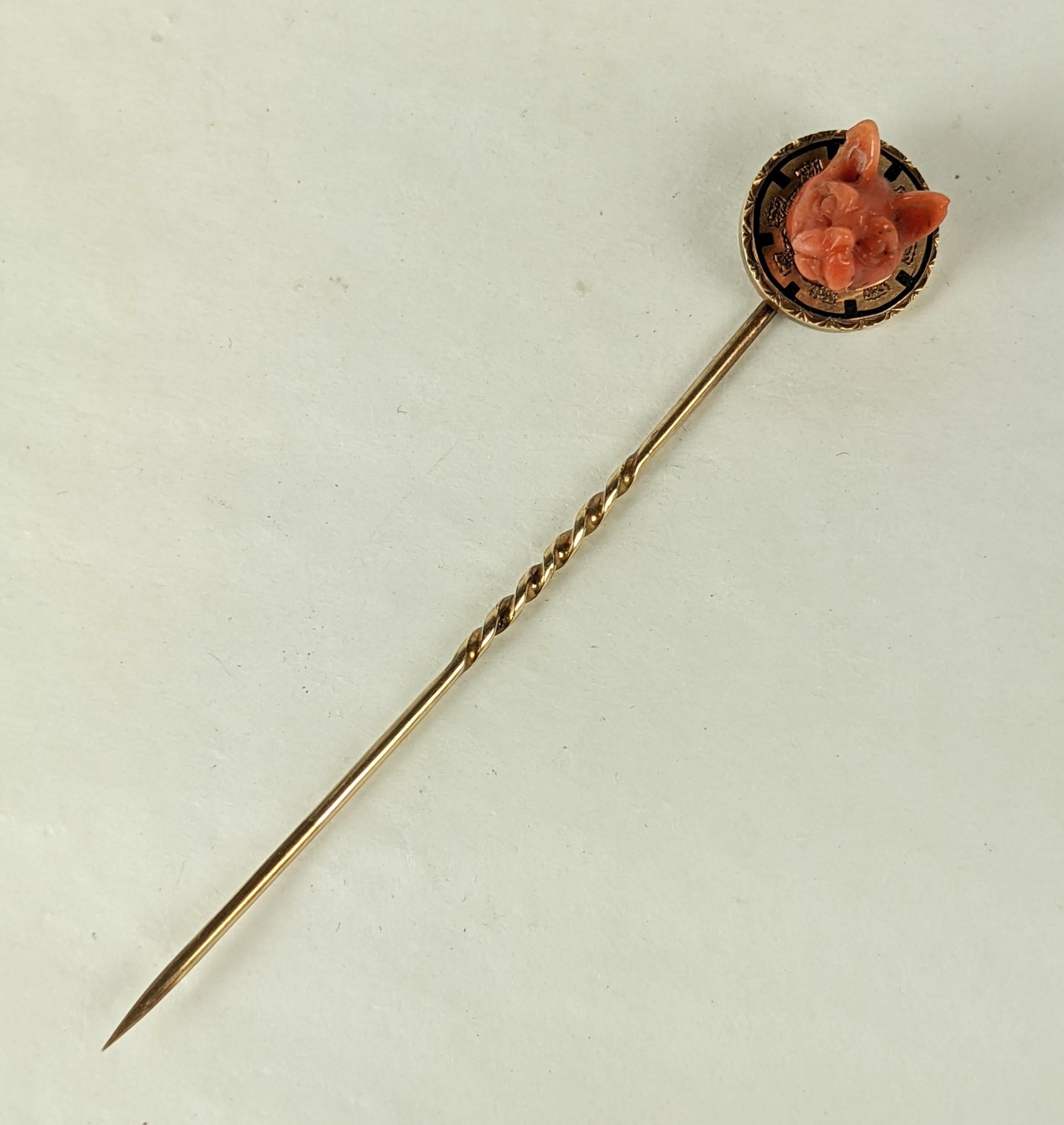 Lovely Victorian Coral Cat Stickpin from the 19th Century. A finely carved 3D cat's head is set on a gold round with black enamel detailing to look like a ruff or collar. 
Superb quality with unusual subject matter.  1870's USA.  .5