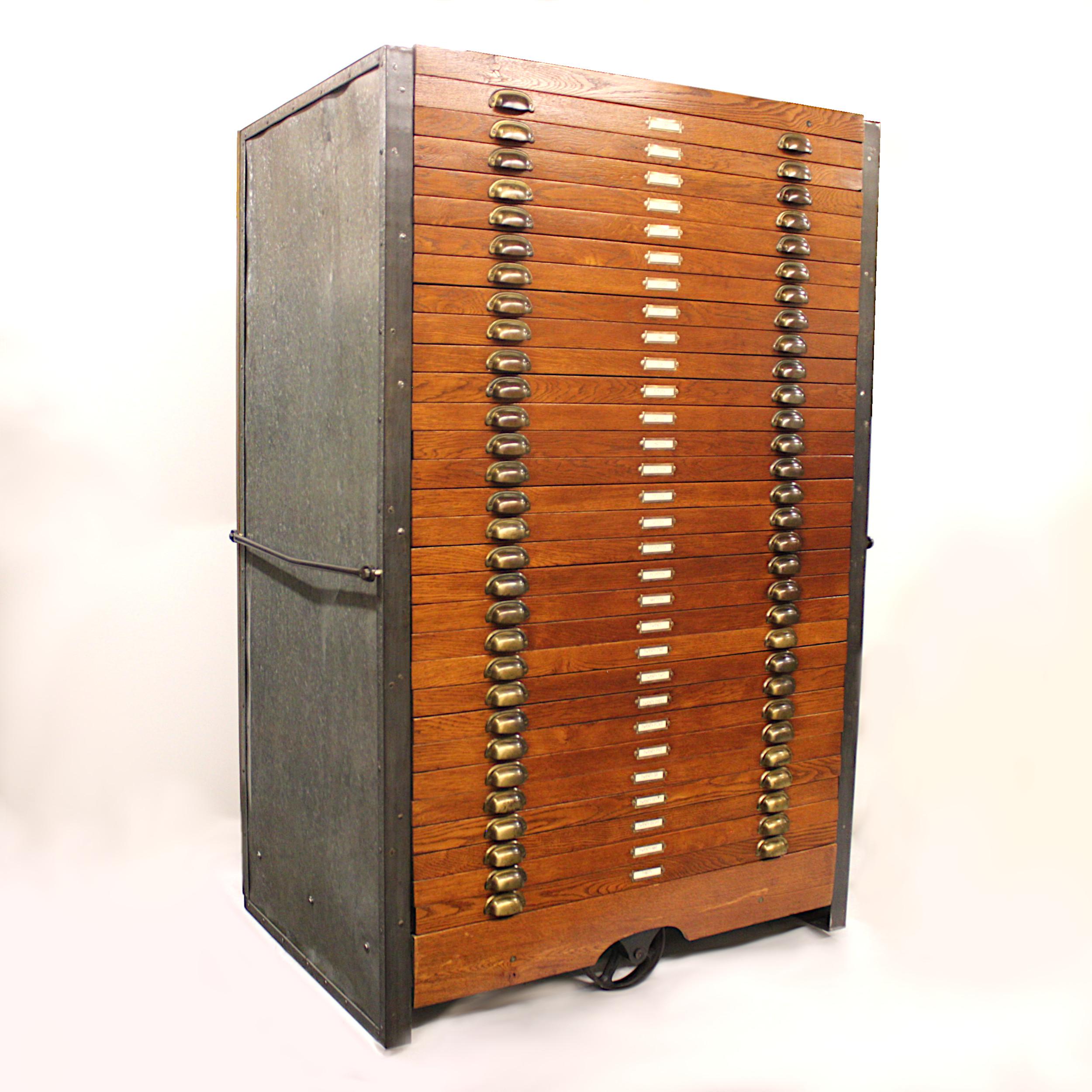 This is a one-of-a-kind rolling flat file cabinet custom made in the late 1940s. Cabinet features the perfect mix of oak, galvanized steel, iron and brass. Standing a full 72