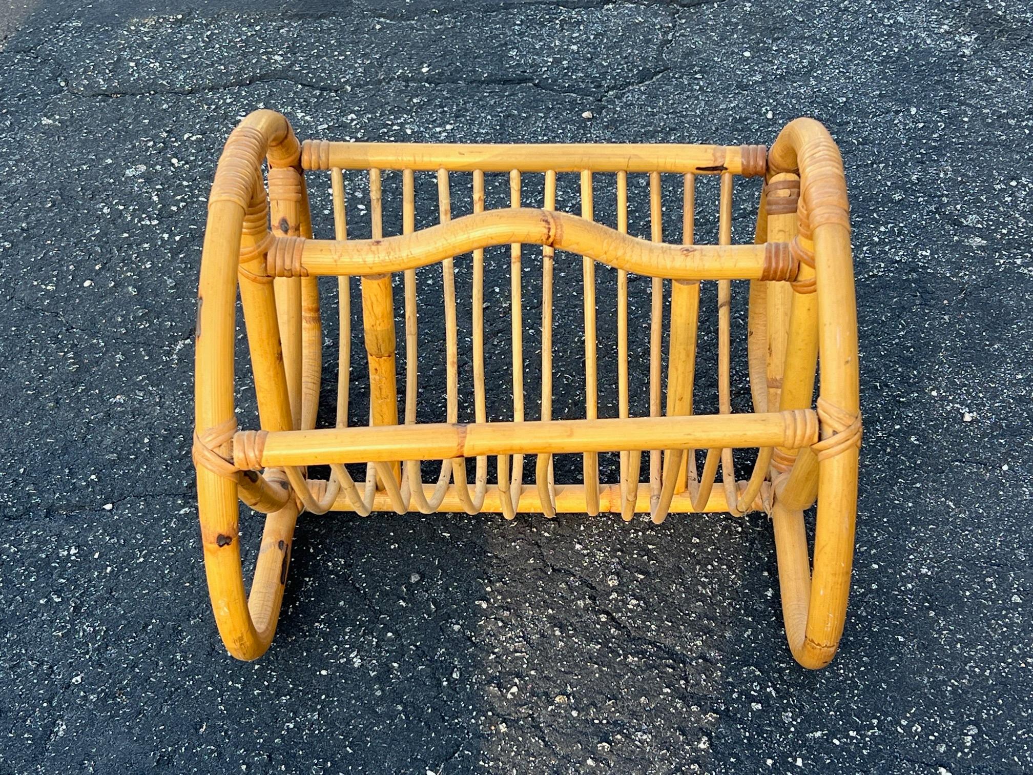  A charming, bamboo magazine holder, ca' 1950's. The middle piece has a bend-so its easier to handle.