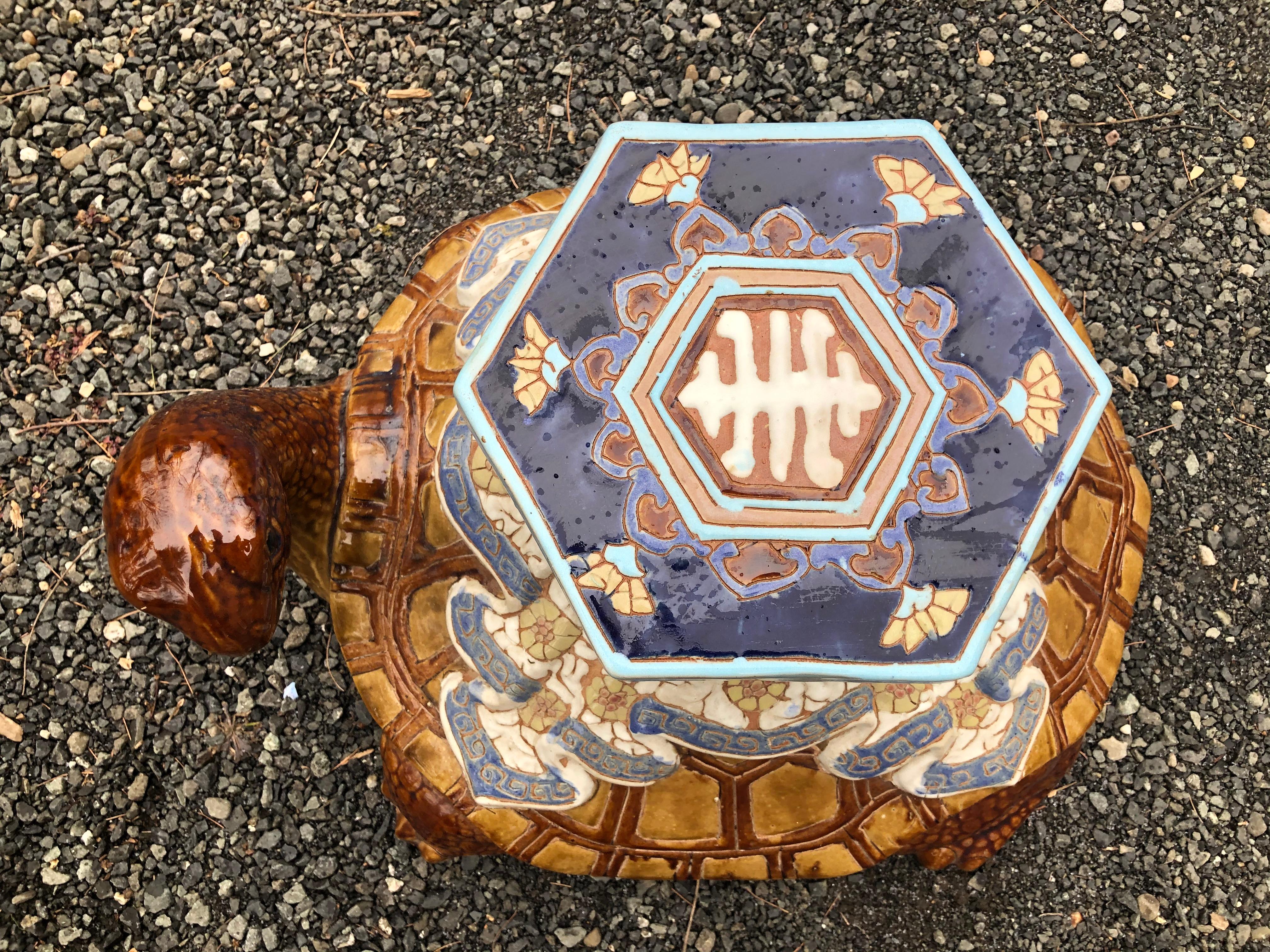 A charming and unique ceramic garden seat in the form of a turtle. From the 1970s, this garden seat is painted predominantly in shades of brown and blue. It is great used indoors or out. Top is 8