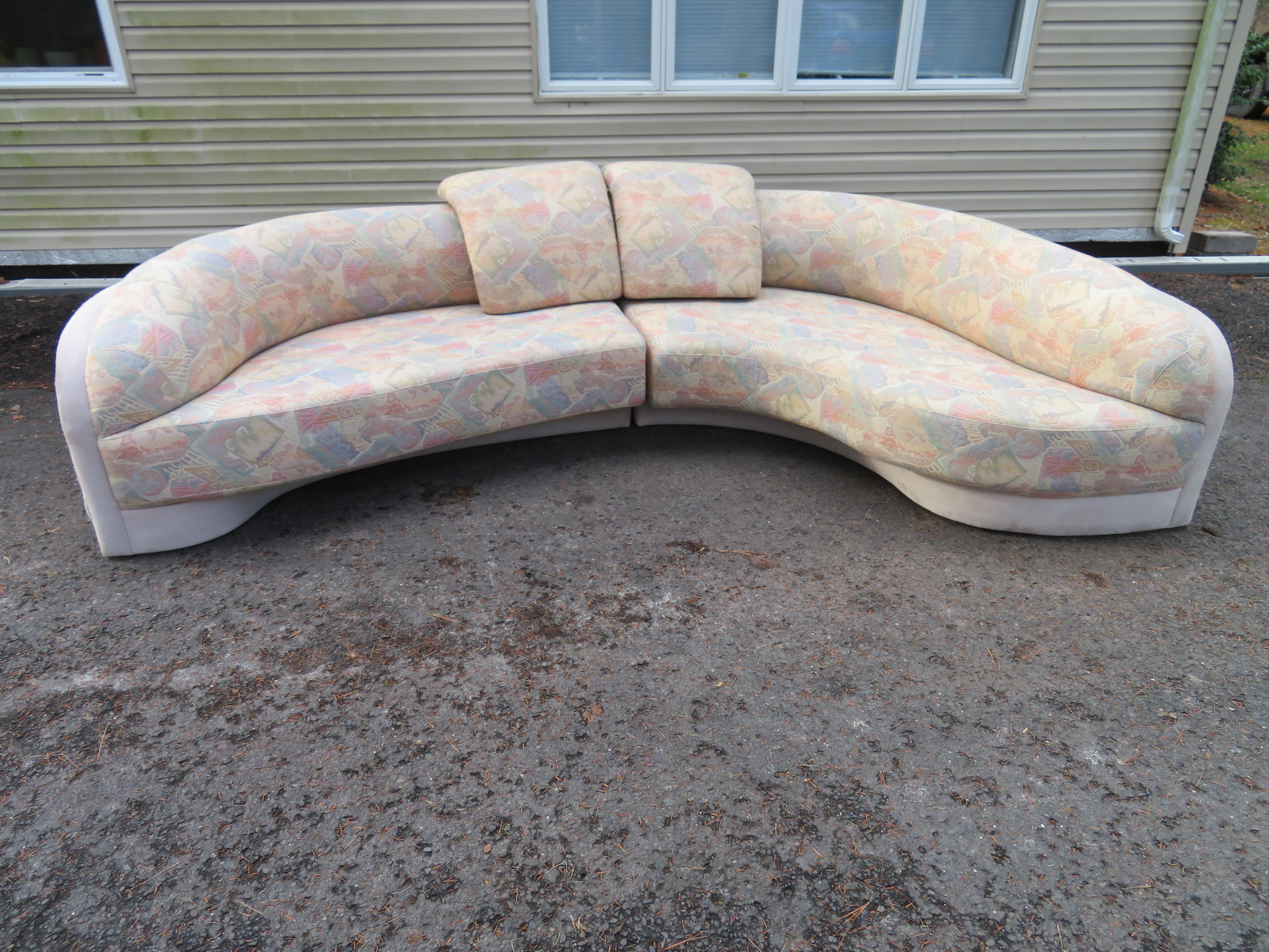Unusual 2-piece curved sectional sofa. We love the wonderful space aged sculpted quality of this sectional-looks great with or with-out the molded pillows. The original fabric is date and we do recommend re-upholstery.