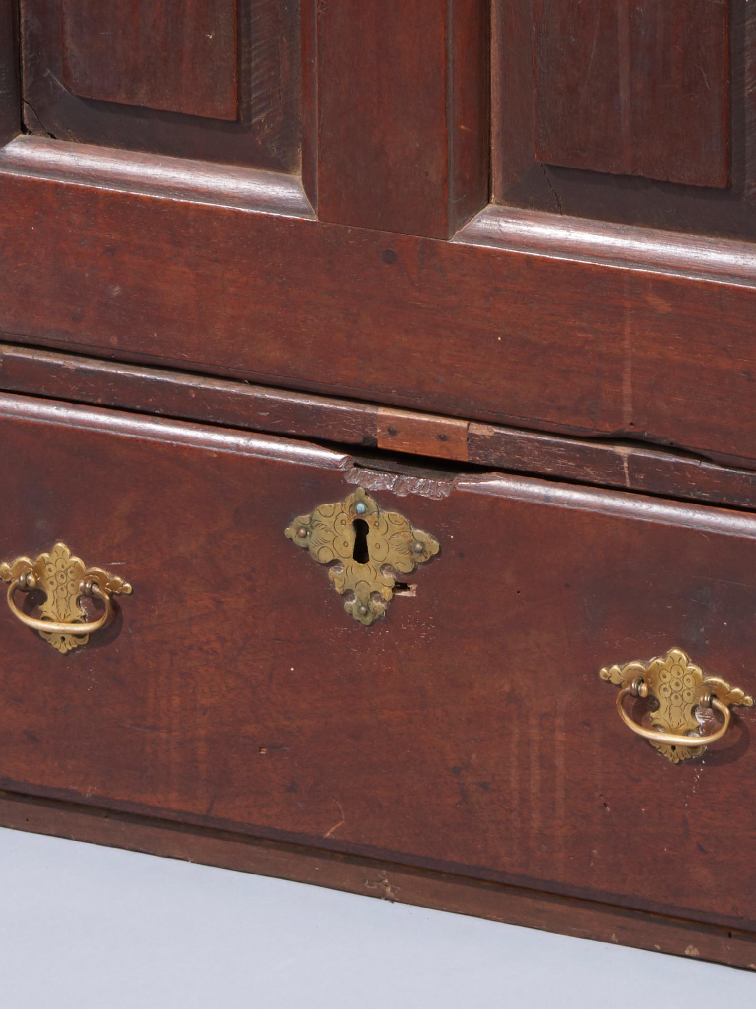 Slant back at the top, double raised panel door and one-drawer below with early engraved brasses, Pennsylvania, circa 1750.