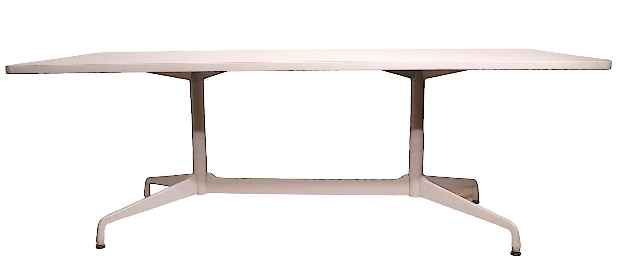 Unusual Eames segmented base conference, dining table, with an off white base and an off white formica table top. The table was originally designed in the 1960's, this example was produced in 2009. Original, clean and ready to use condition, showing