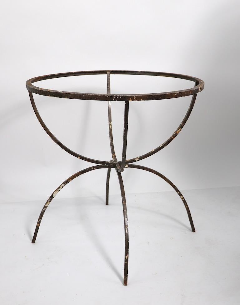 Unusual, architectural wrought iron table base. Currently in older paint finish which shows significant wear and loss. Structurally sound and sturdy, top not included, base only. Usable as is, or we offer custom powder coating if you prefer a more