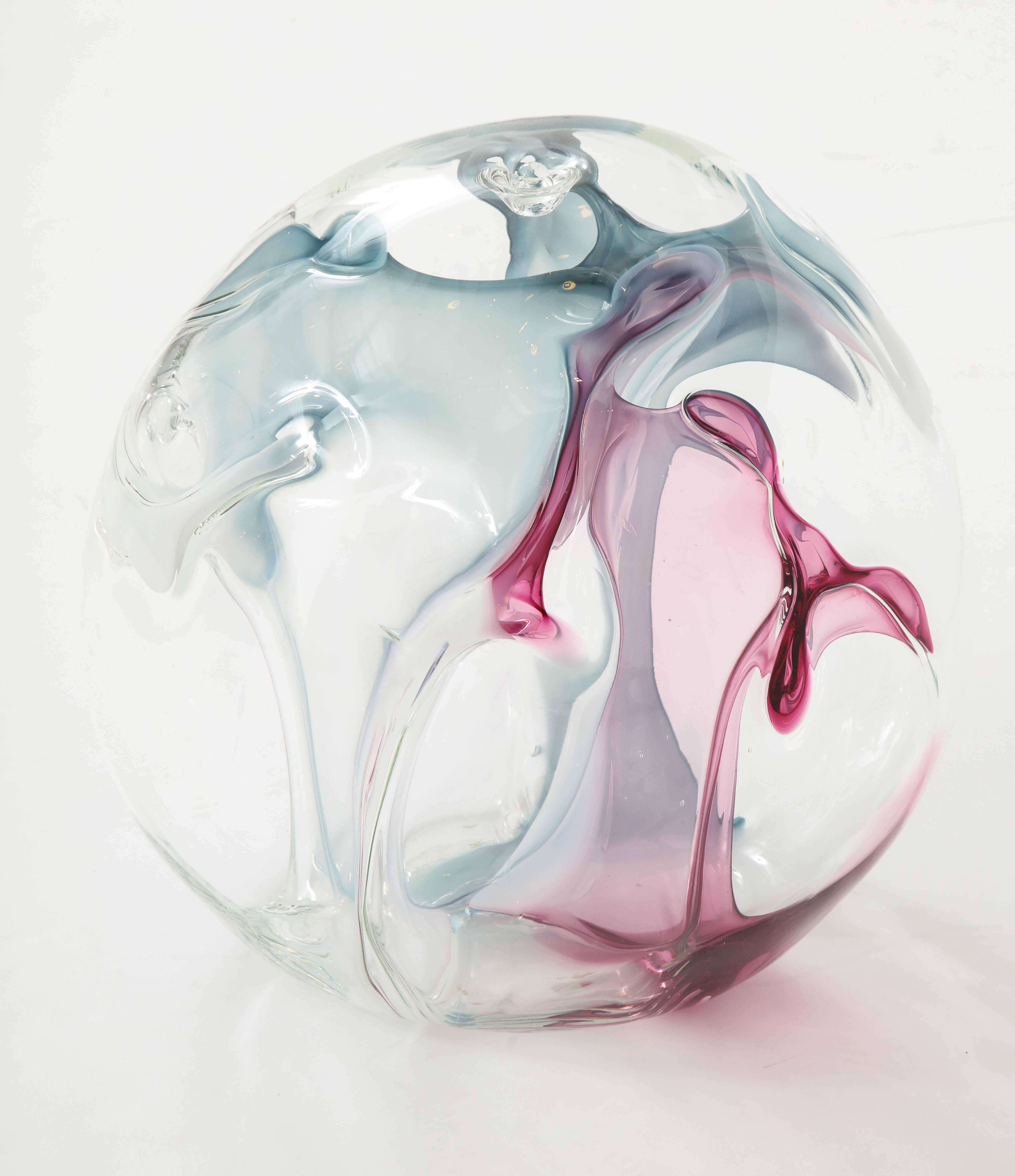 Unusually large glass sculpture by Peter Bramhall.
Hand blown glass sculpture with internal threads of magenta, rose and
ice blue.