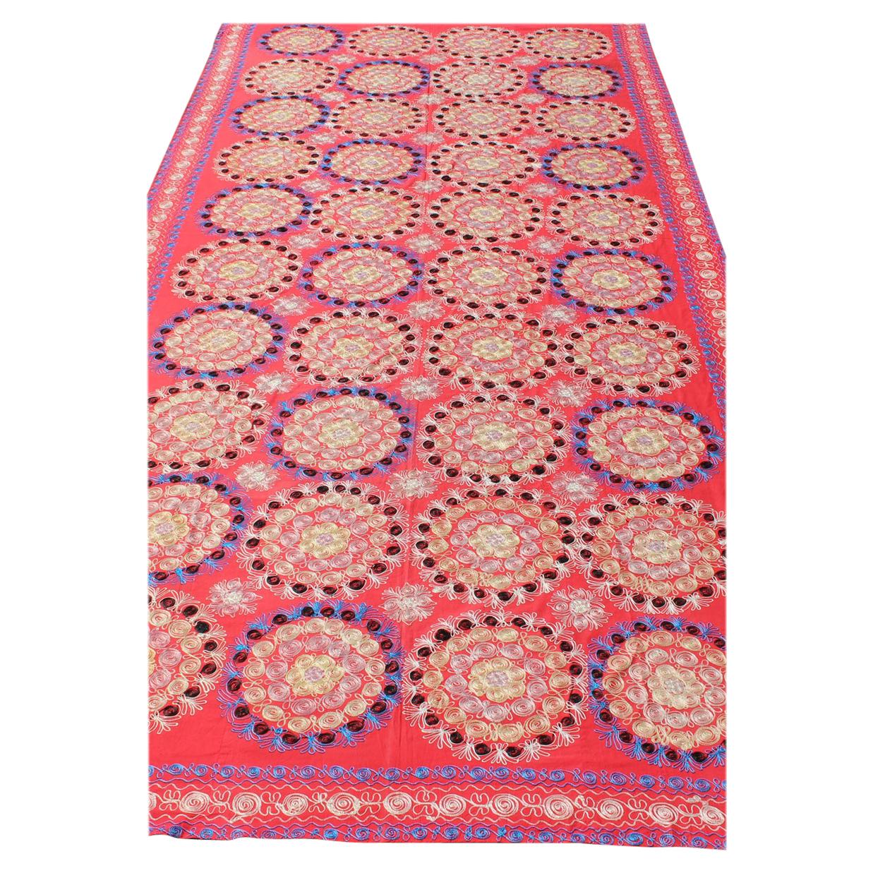 La broderie en soie Suzani est d'une taille inhabituelle, avec un rouge doux et de belles couleurs vives