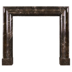 Unusually Shaped English Bolection Moulded Fireplace in Dark Emperador Marble