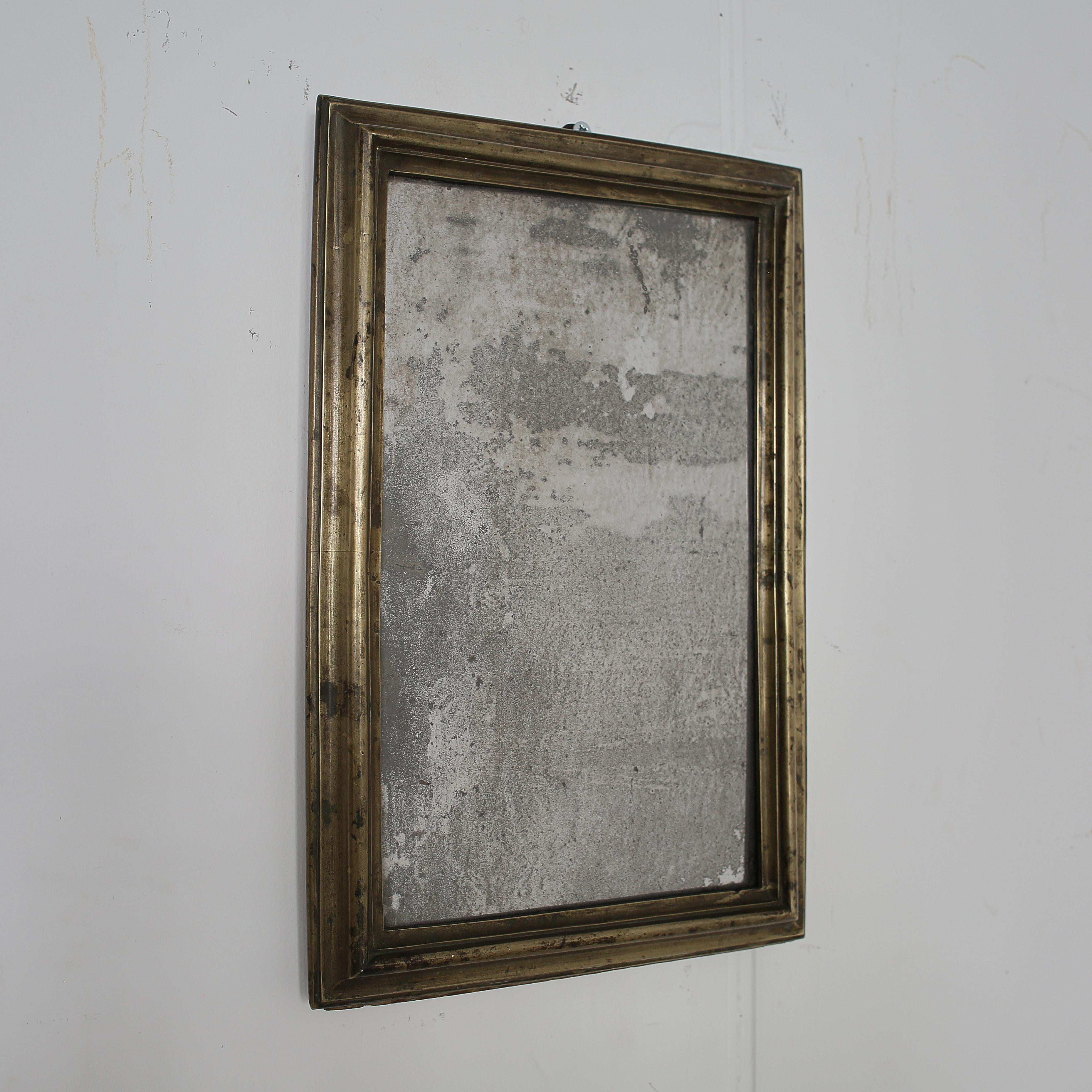 An incredible small French brass bistro mirror with original heavily foxed mirror plate.

Quite possibly an apprentice piece due to its size and attention to detail.