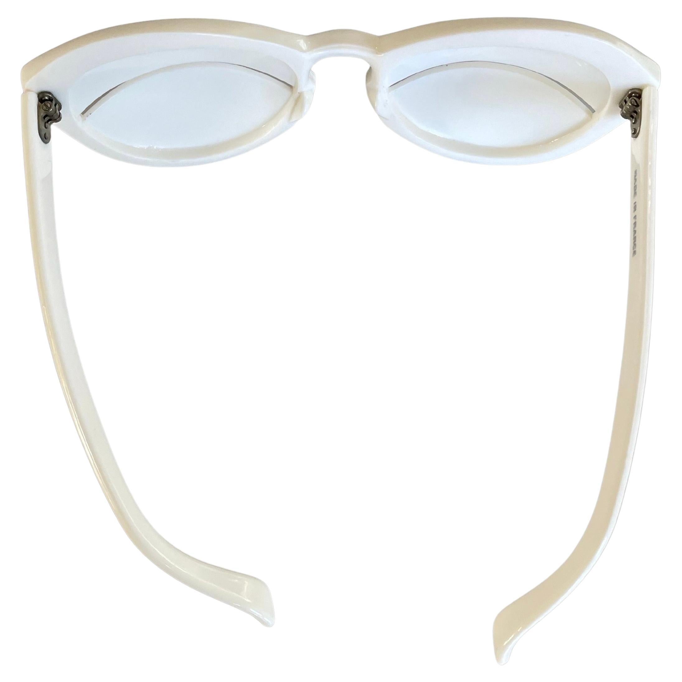 
For sale is this rare pair of Eskimo glasses designed by André Courrèges dating to 1965, an iconic accessory now held in countless museum collections including the collection of the Metropolitan Museum of Art. Molded in white acetate cellulose, the