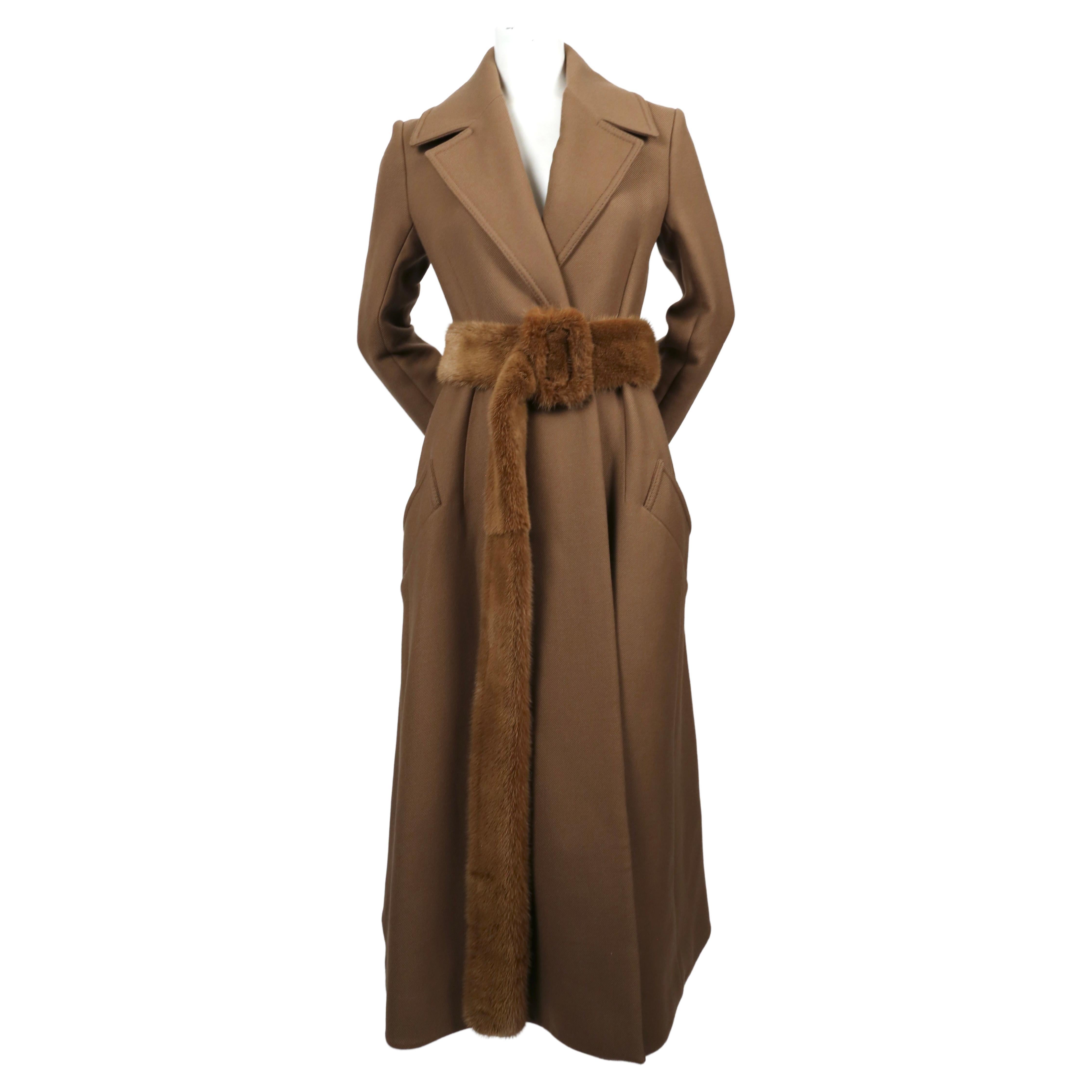 Camel wool gabardine coat with narrow arms and flared hemline with matching extra long mink belt designed by Phoebe Philo for Celine exactly as seen on the fall 2014 runway. French size 38 which best fits a US 2-6. Approximate measurements: shoulder