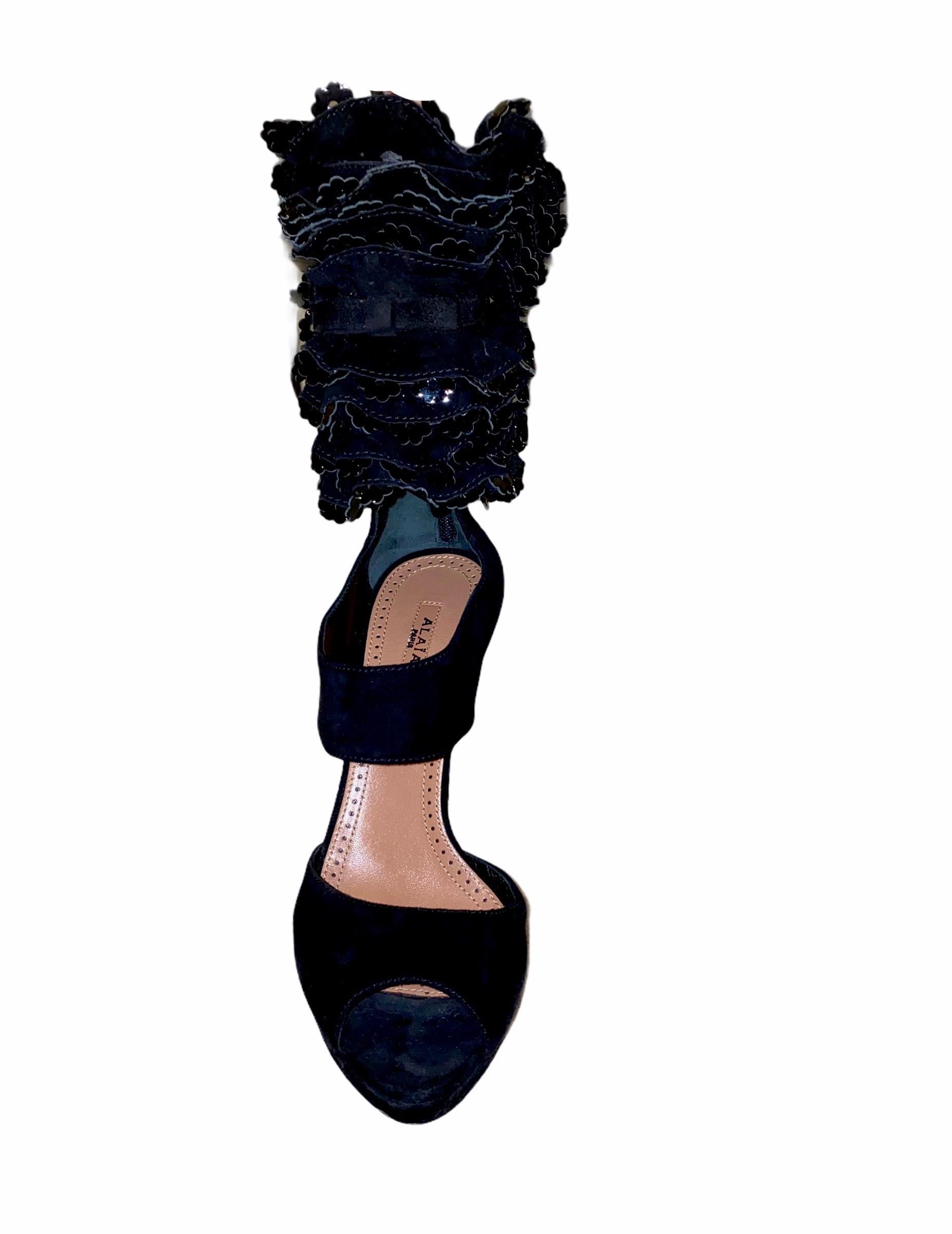 An AZZEDINE ALAIA classic signature piece that will last you for years
This gorgeous pair of heels are made out of finest black suede with ruffle cut-out details at ankles
Zipper closure discreetly engraved with 