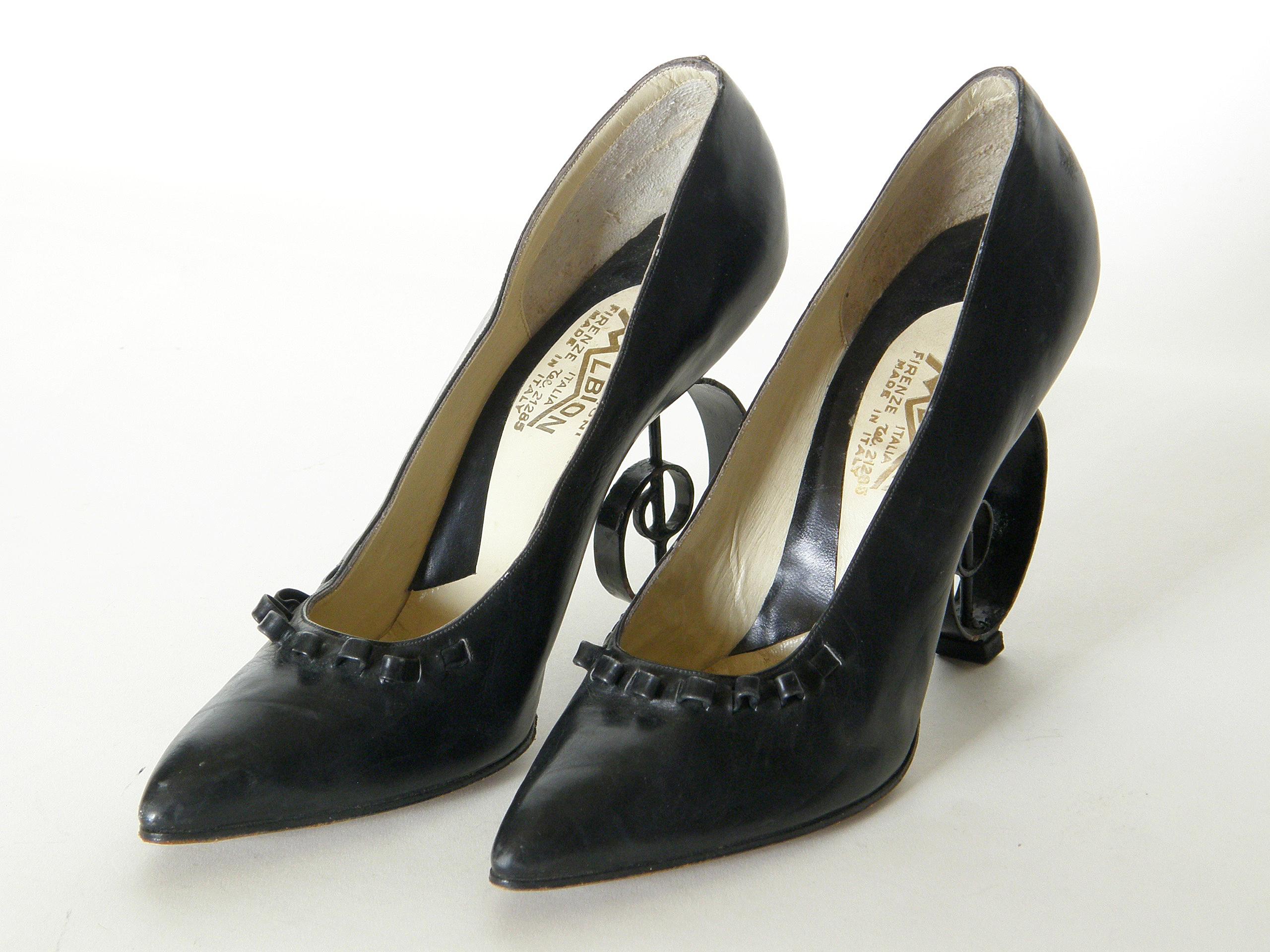 These fantastical Italian leather pumps are a feat of engineering. The unique heels are designed as three-dimensional G-clefs (or treble clefs), and the vamp has a playful strip of leather that laces through slits and undulates along the edge.