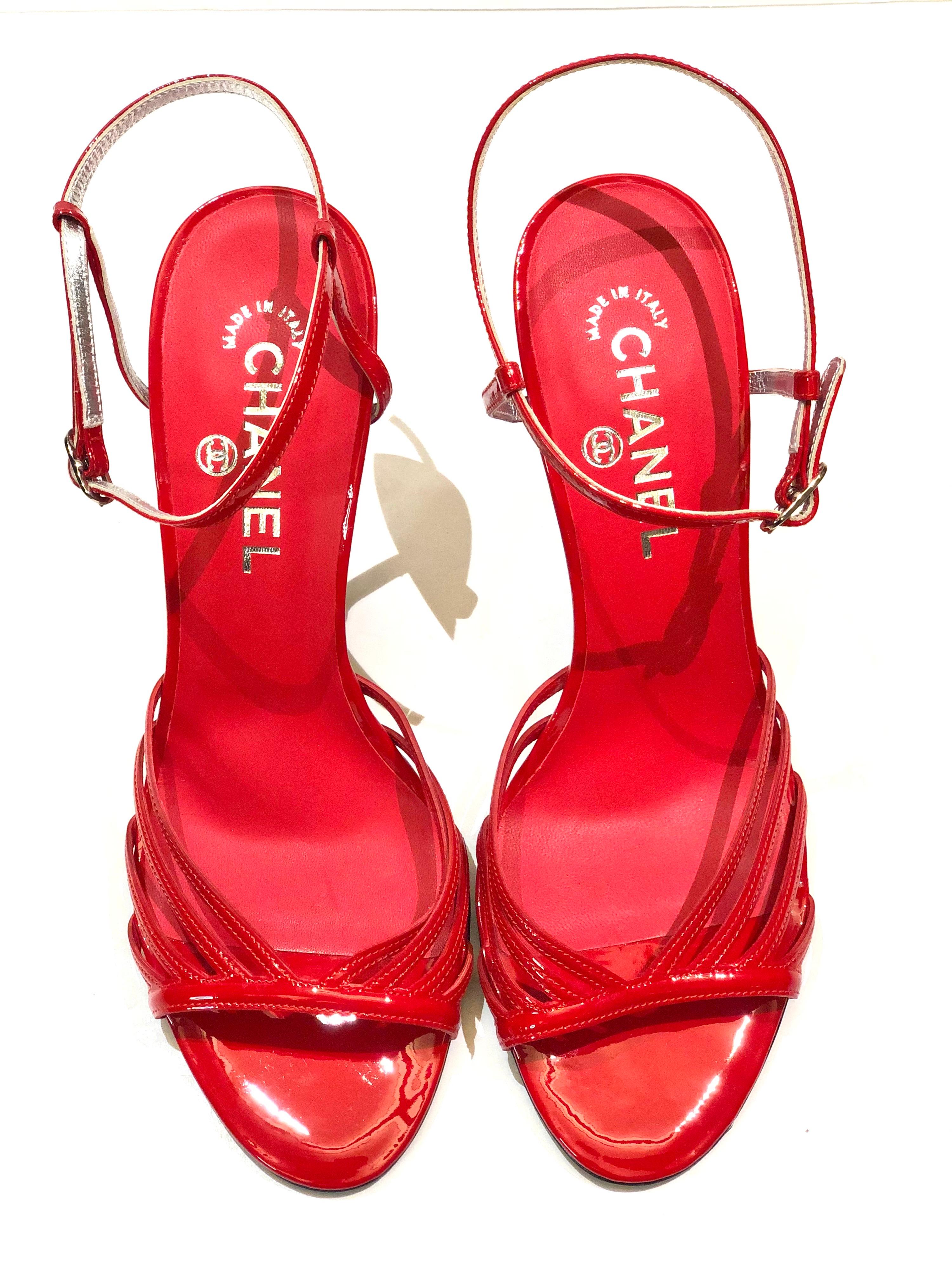 - Unworn Chanel red patent leather straps sandals with silver toned metal hardware 