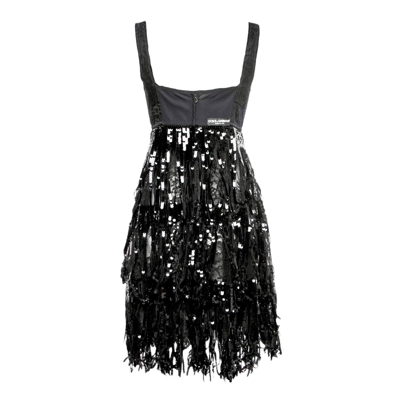 A DOLCE & GABBANA classic signature piece that will last you for years
Stunning dress with corset style top 
Lower part made of several layers of lace
Black sequin fringes layered over the skirt part
Dolce & Gabbana label on back
An amazing & unique