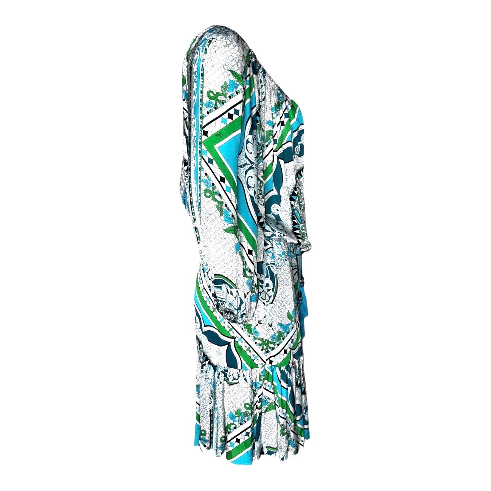 Bright colors illuminate the signature Emilio Pucci print covering a free-spirited silk dress. 
Gathers at the neckline, cuffs and waist shape the blousy silhouette, while tassels dangle above the flirty front keyhole. The versatile style can be