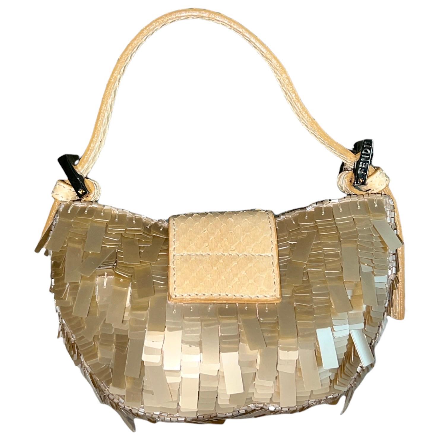 Special Piece!
Stunning Micro Baguette Bag by Fendi
Champagne-colored satin beautifully embroidered with sequins & pearls
FF Logo buckle closure
Exotic snakeskin trimming
Adjustable strap
Satin internal lining
Inner plaque with engraved Fendi