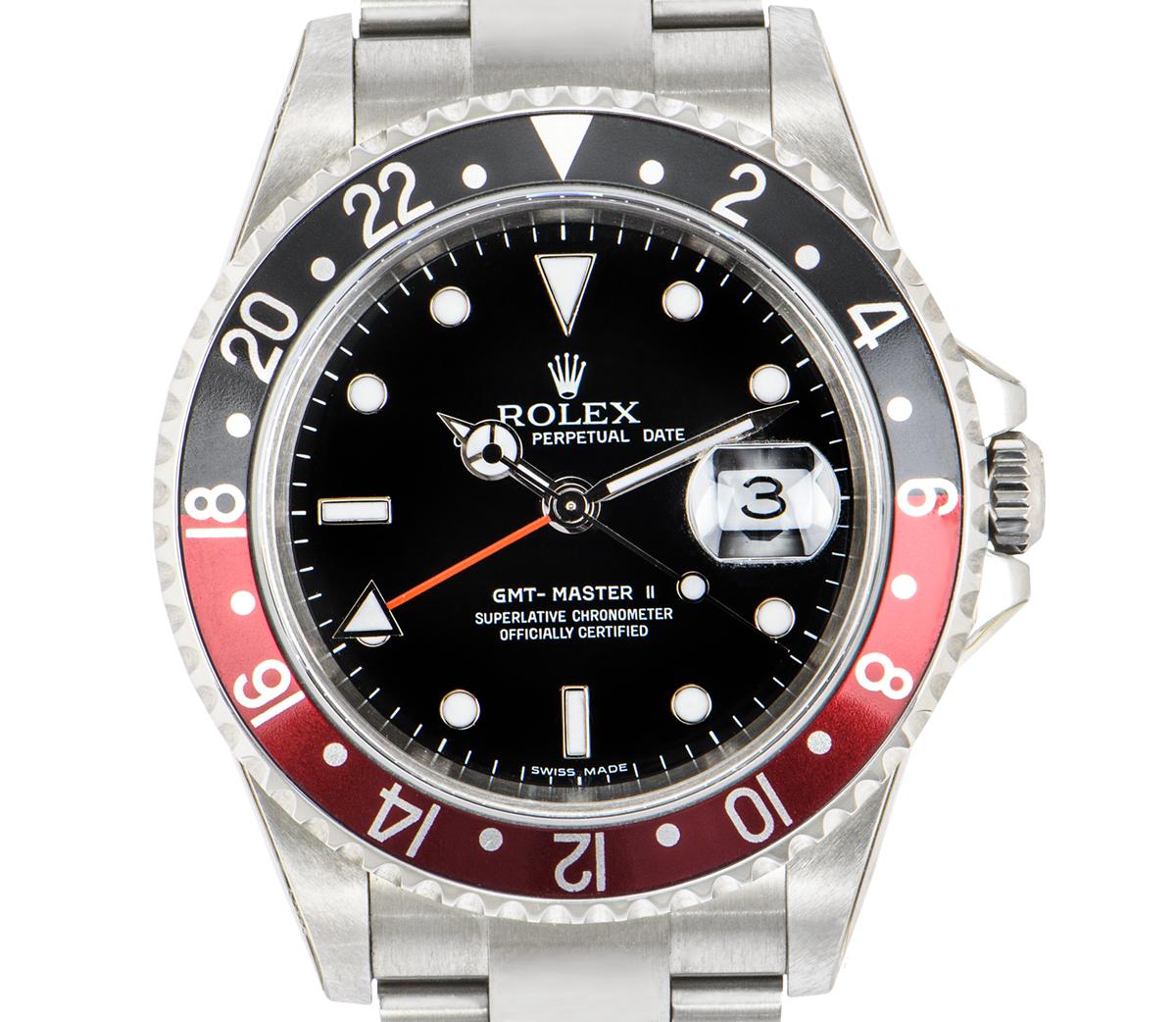An Unworn NOS stainless steel 40mm GMT-Master II by Rolex, featuring a rare black stick dial with the date and a red second-time zone hand. The bidirectional rotatable bezel features a 24-hour display and a red and black 