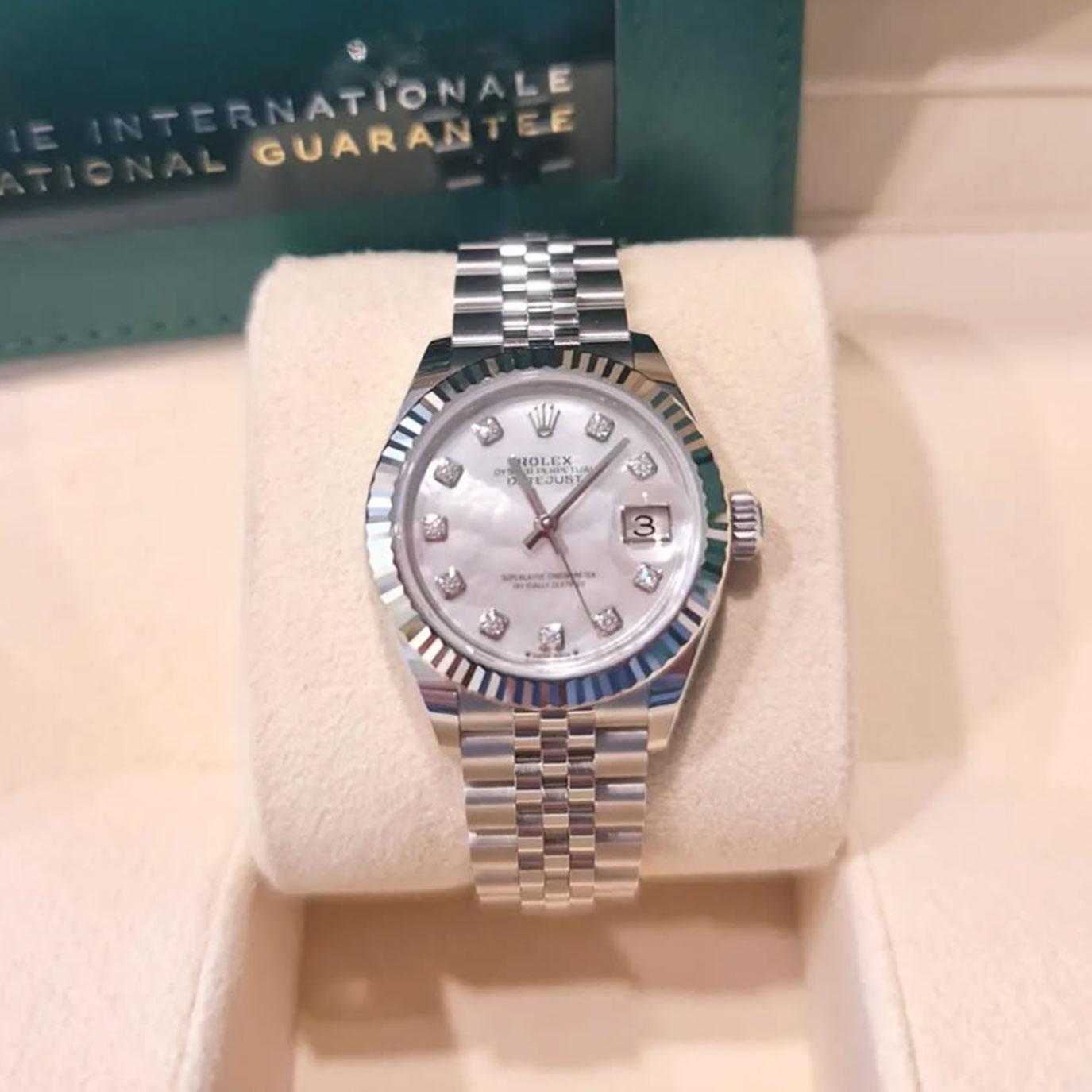 The Rolex Datejust 28 279174-0009 is a refined statement of classic elegance in a petite, luxurious form. Crafted in Oystersteel and crowned with an 18k white gold fluted bezel, this 28mm model balances durability with timeless sophistication. Its