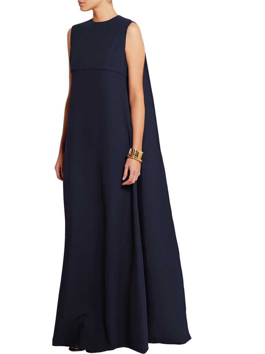 Valentino's midnight-blue gown is cut from silk-cady - it hangs beautifully and is unlined to enhance the fluid feel. The full-length cape overlay flutters gracefully as you walk, so maximize the effect by wearing it with heels.

Gorgeous midnight