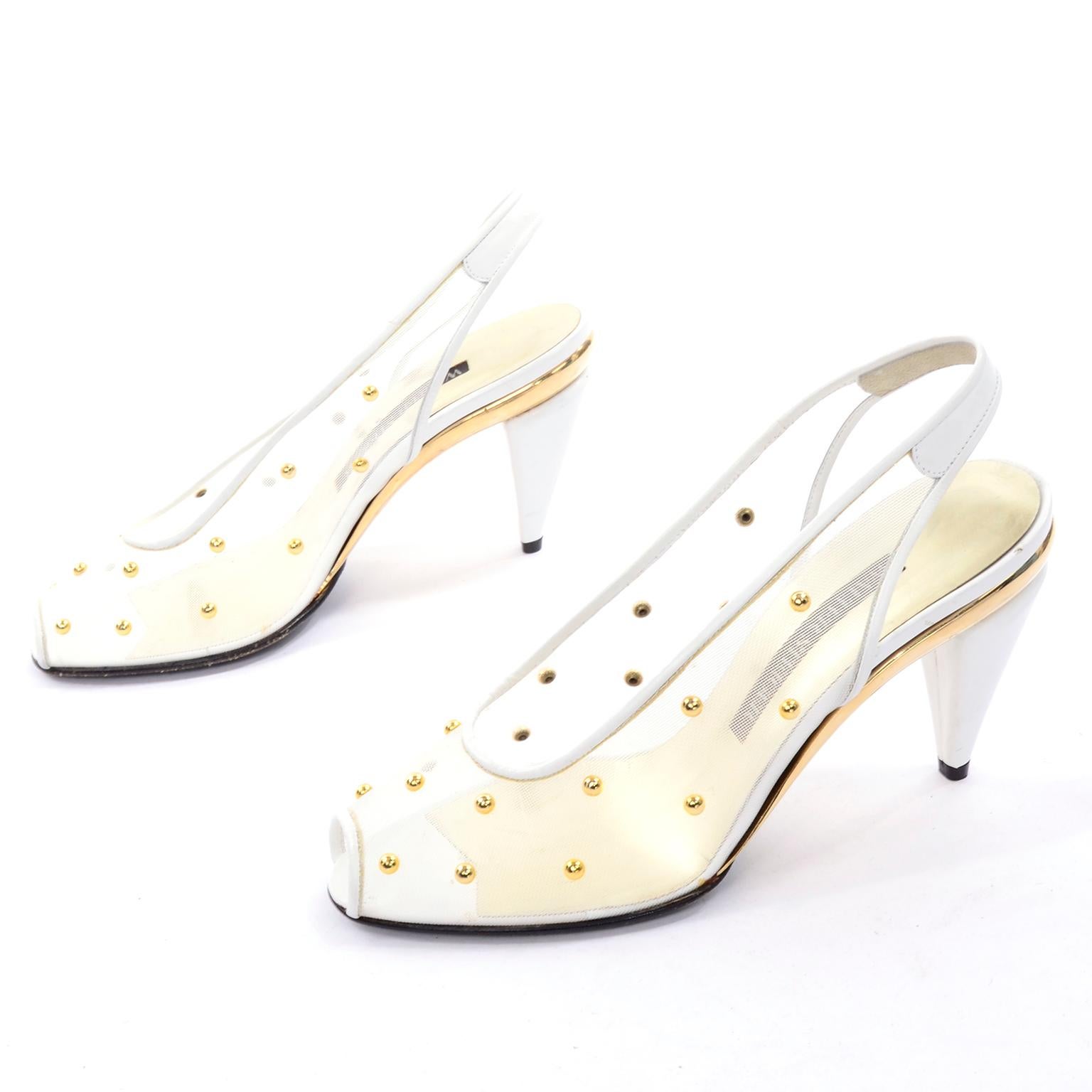 These are stunning vintage Walter Steiger white mesh slingback heels covered in gold tone dome studs. These vintage shoes have a leather sole and peep-toe. We love the gold part of the soles! These would make great wedding shoes! They appear never