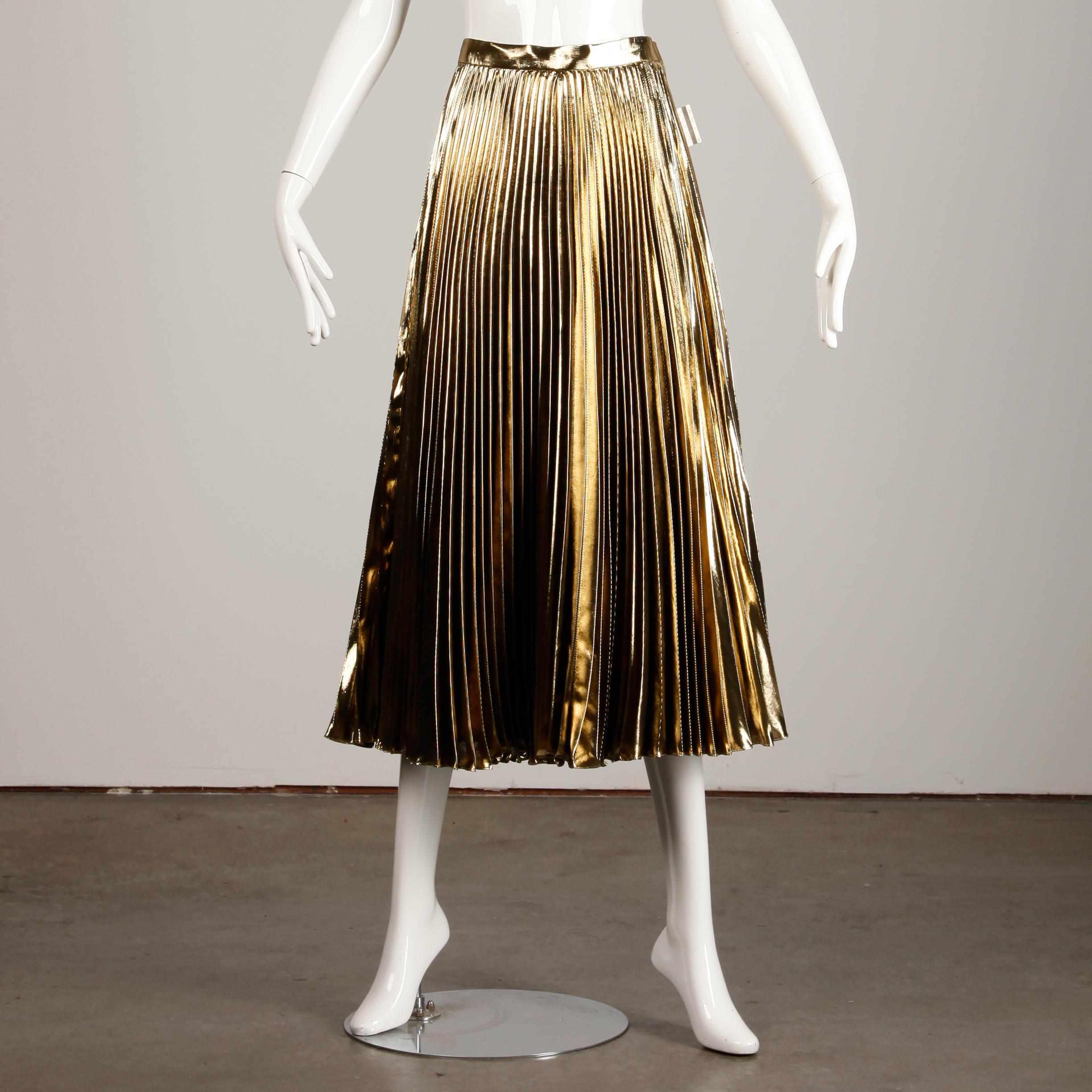 Unworn with the original $258.00 tags attached from Macy's! This vintage skirt features shiny metallic gold lamé pleated fabric with a huge sweep. Will fit as a midi or maxi skirt depending on your height. The marked size is a US 12 but the skirt