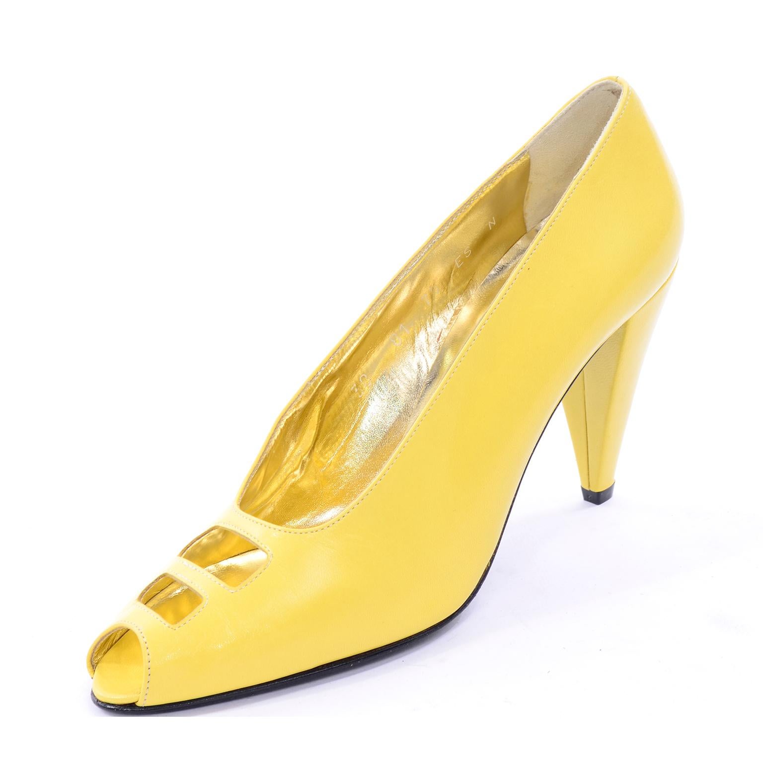 These are gorgeous yellow leather Escada peep toe heels from the 1980's. They have rectangular cutouts in the uppers and were made in Italy.. Excellent condition and have never been worn! 7.5AA is the marked size. HEEL: 3.75