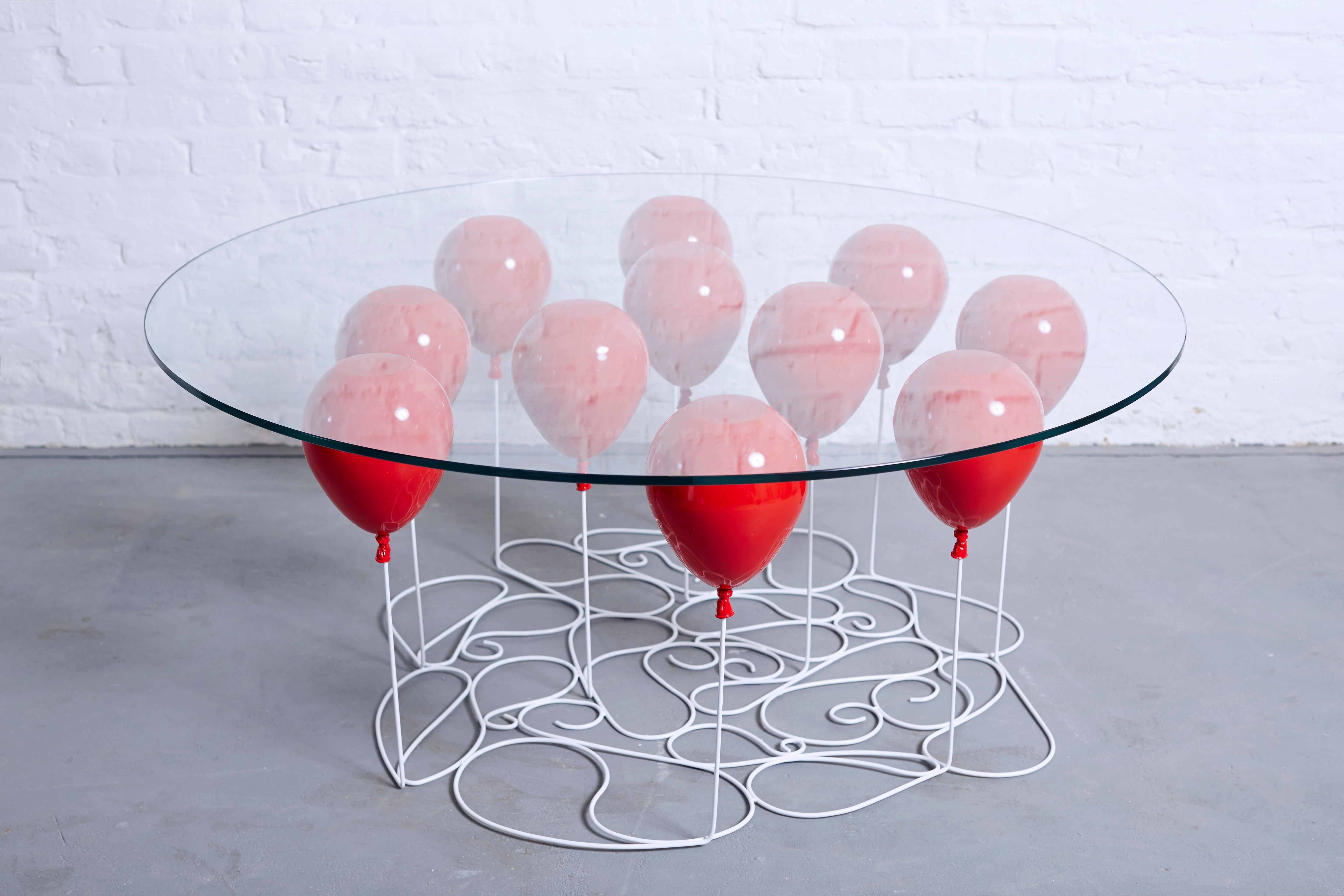 The UP Balloon Coffee Table is a playful trompe l’oeil with gold and silver balloons impressing the illusion of a levitating glass tabletop. 

An uplifting design from acclaimed British designer Christpher Duffy that captures the imagination,