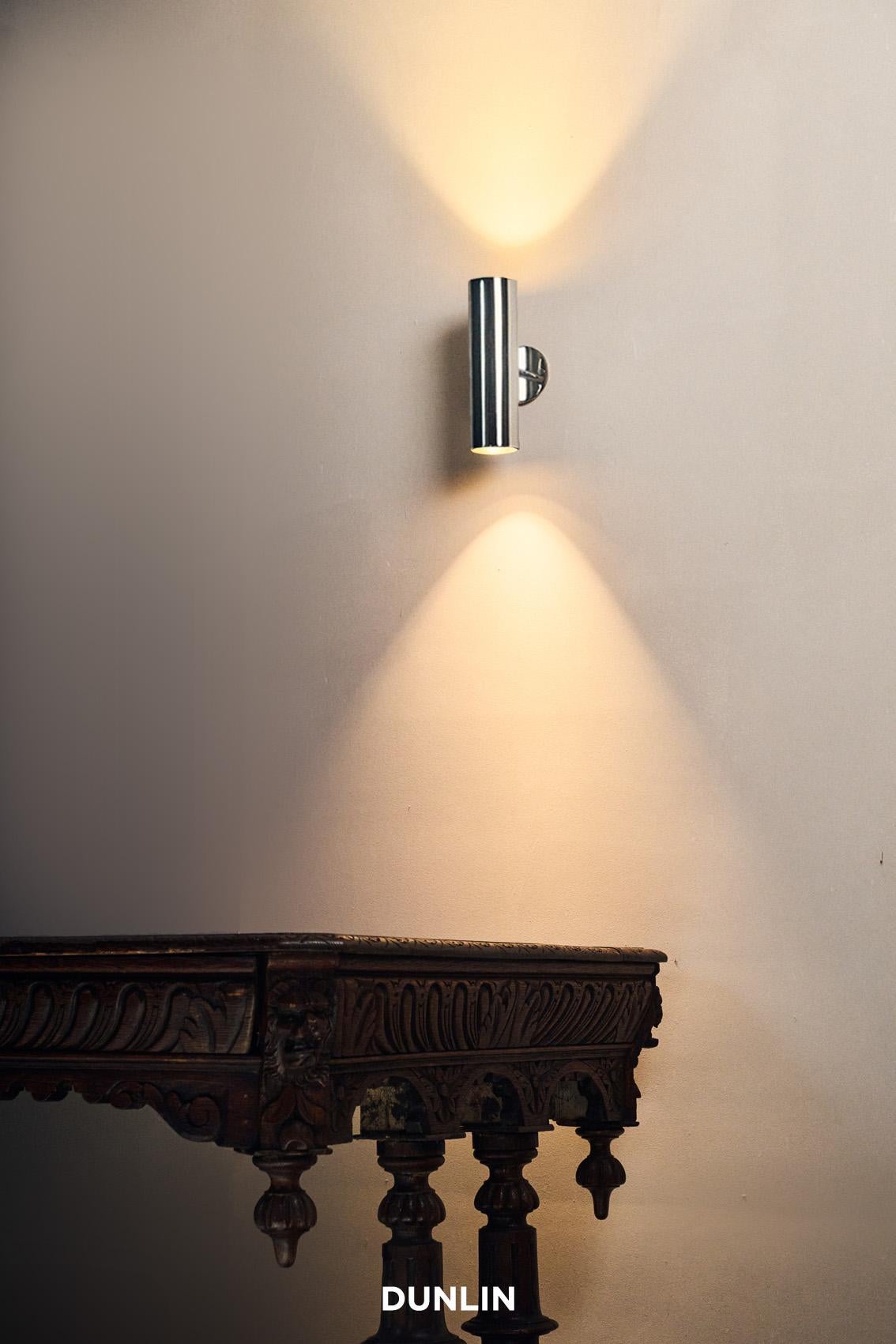 Handmade in solid brass in Sydney, Australia by Dunlin. 

A playful up-down light in solid brass.
Measures: 6.3 cm Diameter x 22 cm Long
Finish: Nickel Plated Brass
Two lamp holders direct light vertically up and down, or sideways if installed
