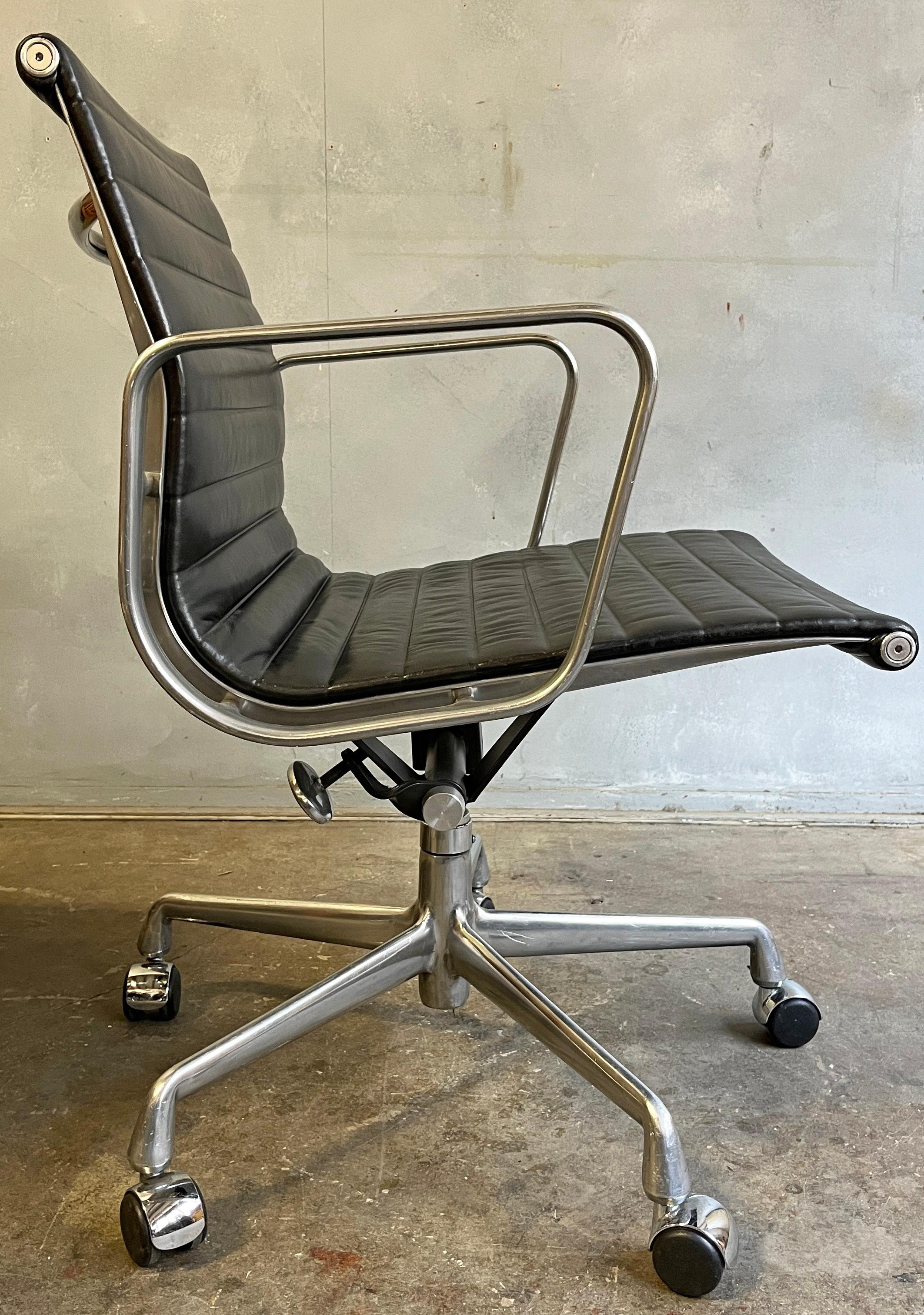 Up to 8 aluminum group chairs in black leather designed by Eames for Herman Miller. In very good vintage original condition showing minimal wear for 30 year old chairs. With manual tilt and height adjustment. Wheels are for hard wood floor surfaces.