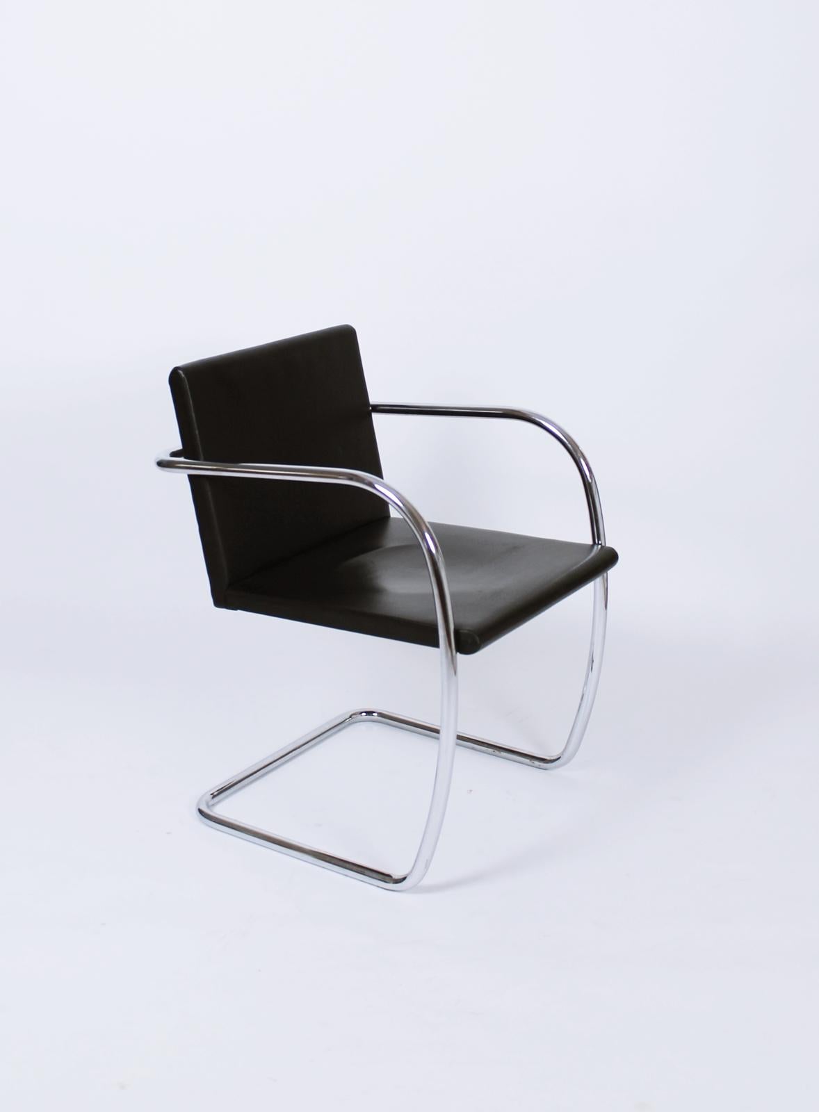 A Mid-Century Modern tubular Brno chair designed by Ludwig Mies van der Rohe. This is the rarer version with the thin pad seat and back. A steel frame upholstered in black leather. As shown in the first image, we have a four of these available.