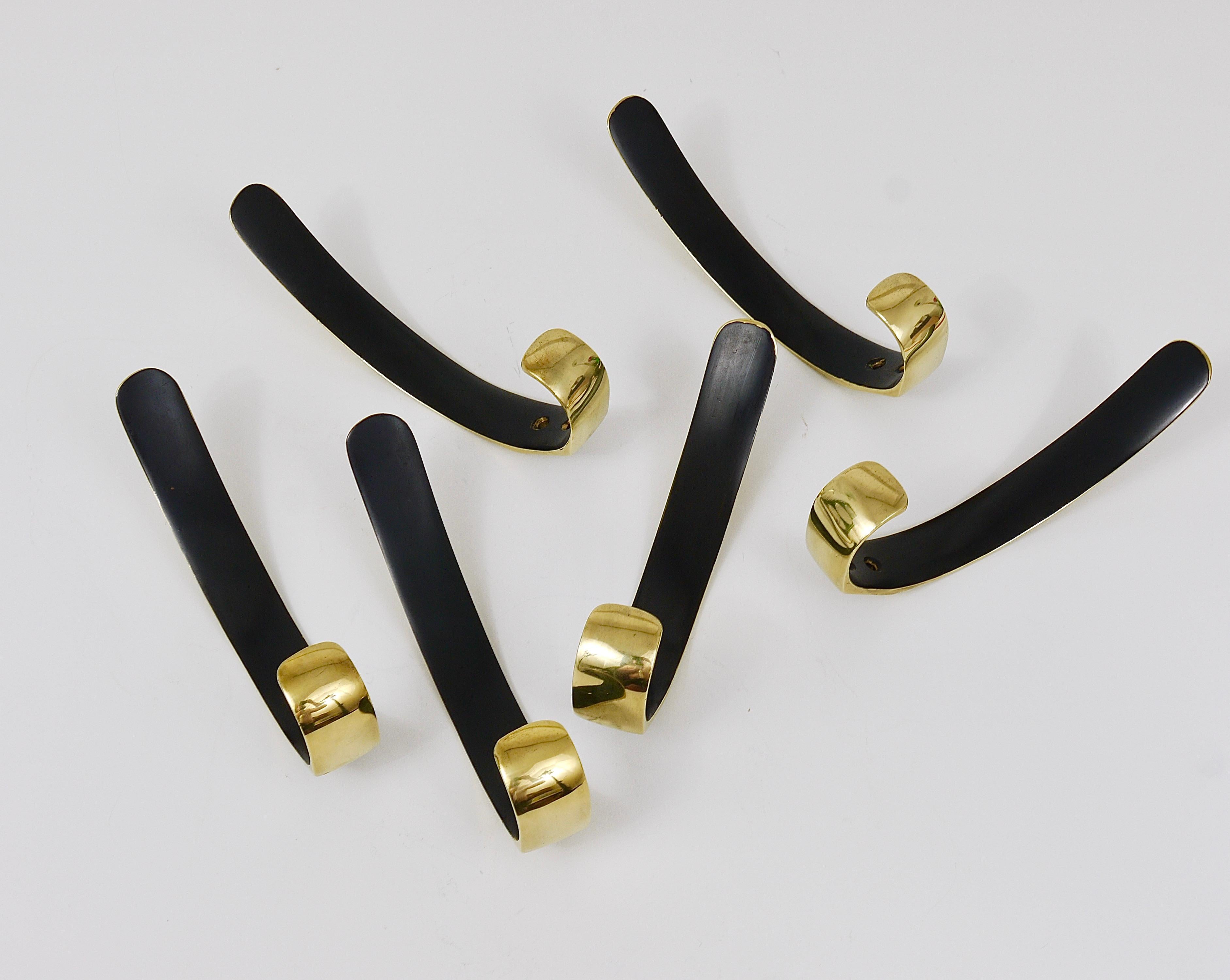 Up to six beautiful and elegant modernist brass wall hooks in the style of Carl Aubock. Executed in the 1950s by Hertha Baller, Austria. Solid brass, partly polished and partly black patinated. In very good condition with marginal patina. Six hooks