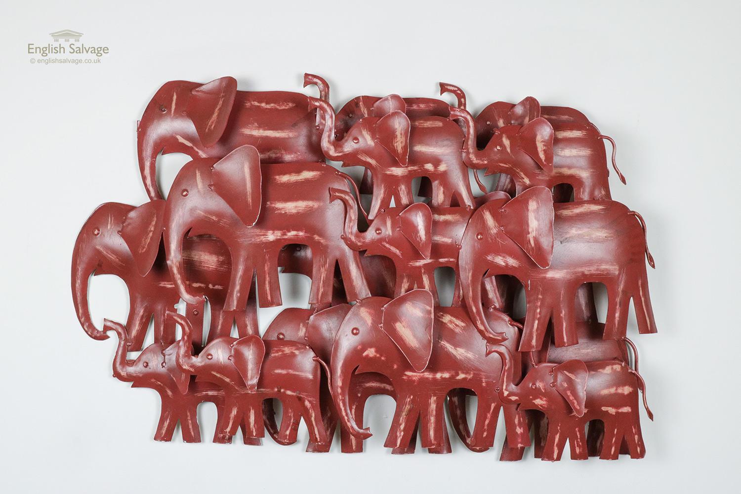 Funky double layered wall hanging / wall art featuring a herd of adult and baby elephants. handmade from upcycled metal and hand painted in a nice brick red color with lighter accents. Two wall hooks to the back.