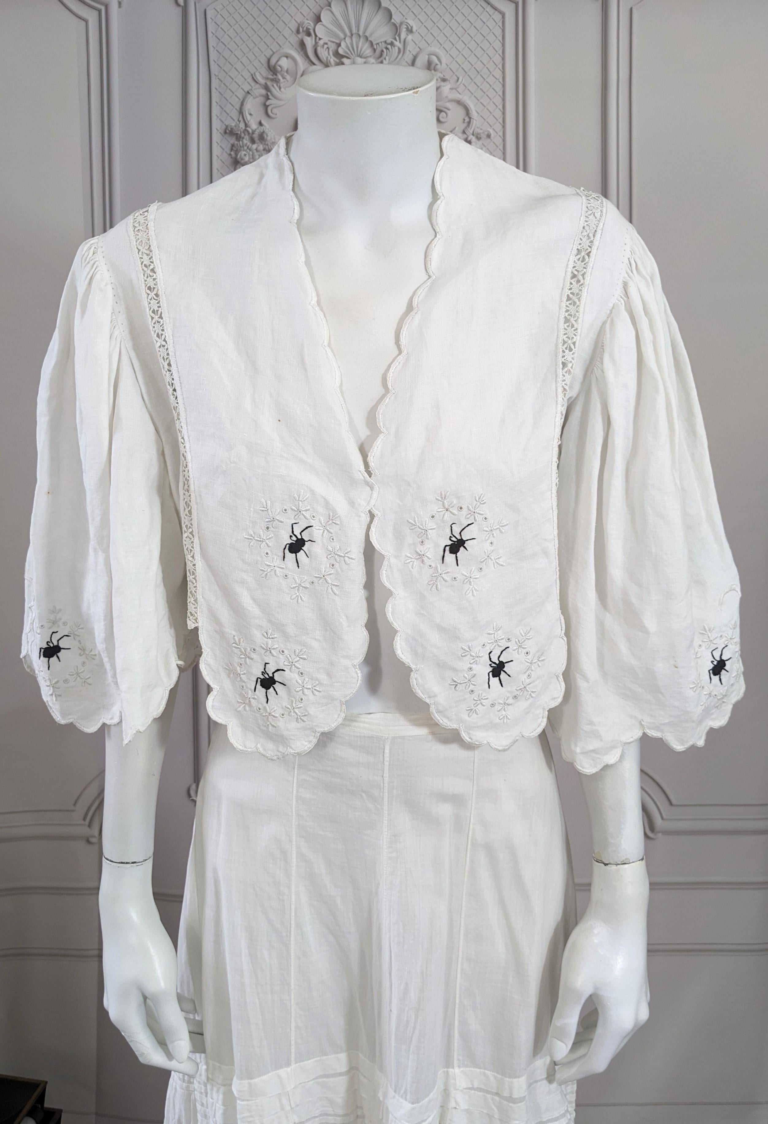 Upcycled Victorian Linen Spider Bolero by Studio VL. We have hand embroidered a series of tiny black spiders within each original embroidered cartouche on the body and along the hems of sleeves. Very full bell sleeves in full bodied linen. No