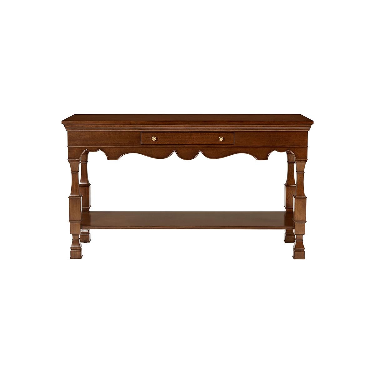 In a warm medium polished finish, the console has a rectangular top above a frieze with three drawers and a scalloped apron. Raised on carved column legs and a shelf stretcher base.

Dimensions: 58