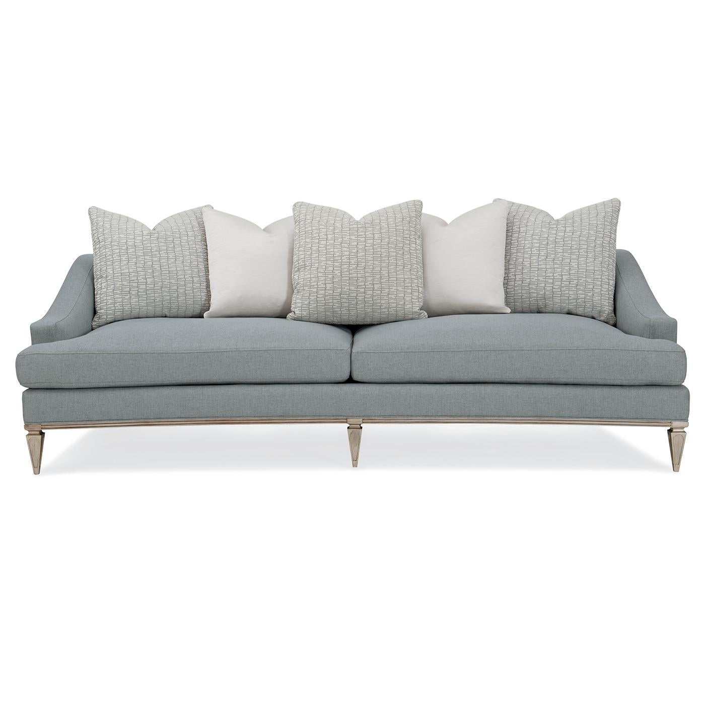 Updated Traditional Sofa that is stylishly expressive with its low-key elegance. A low back and sloping arms cradle the loose back pillow and create an updated traditional aesthetic that's tailored to perfection. It features two seat cushions and is