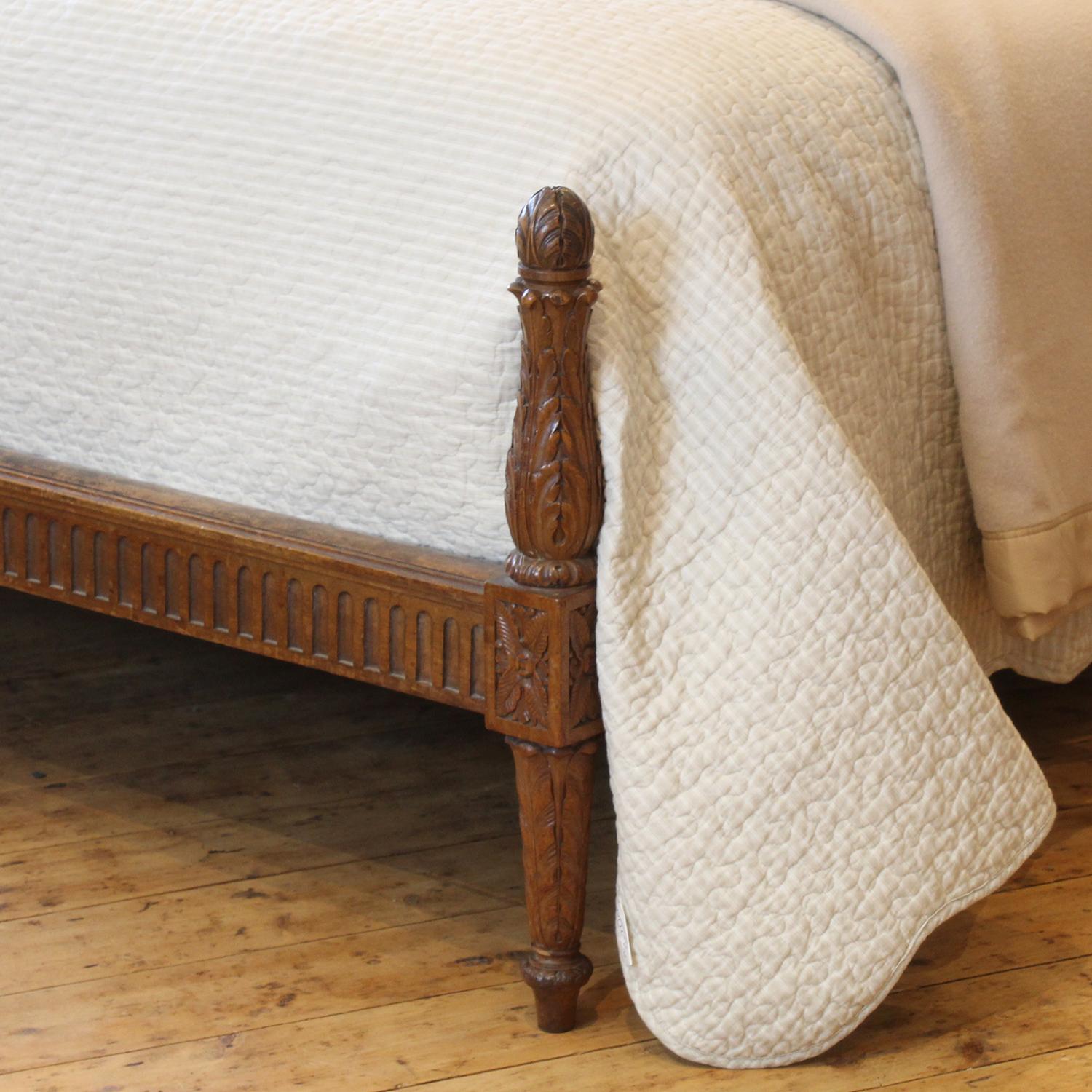 A fine antique bed in walnut with arched back panel upholstered with cherub fabric, and torchon foot.

This bed accepts a British king size or American queen size, 5ft wide (60 inches or 150cm) base and mattress set, with an overlap (as