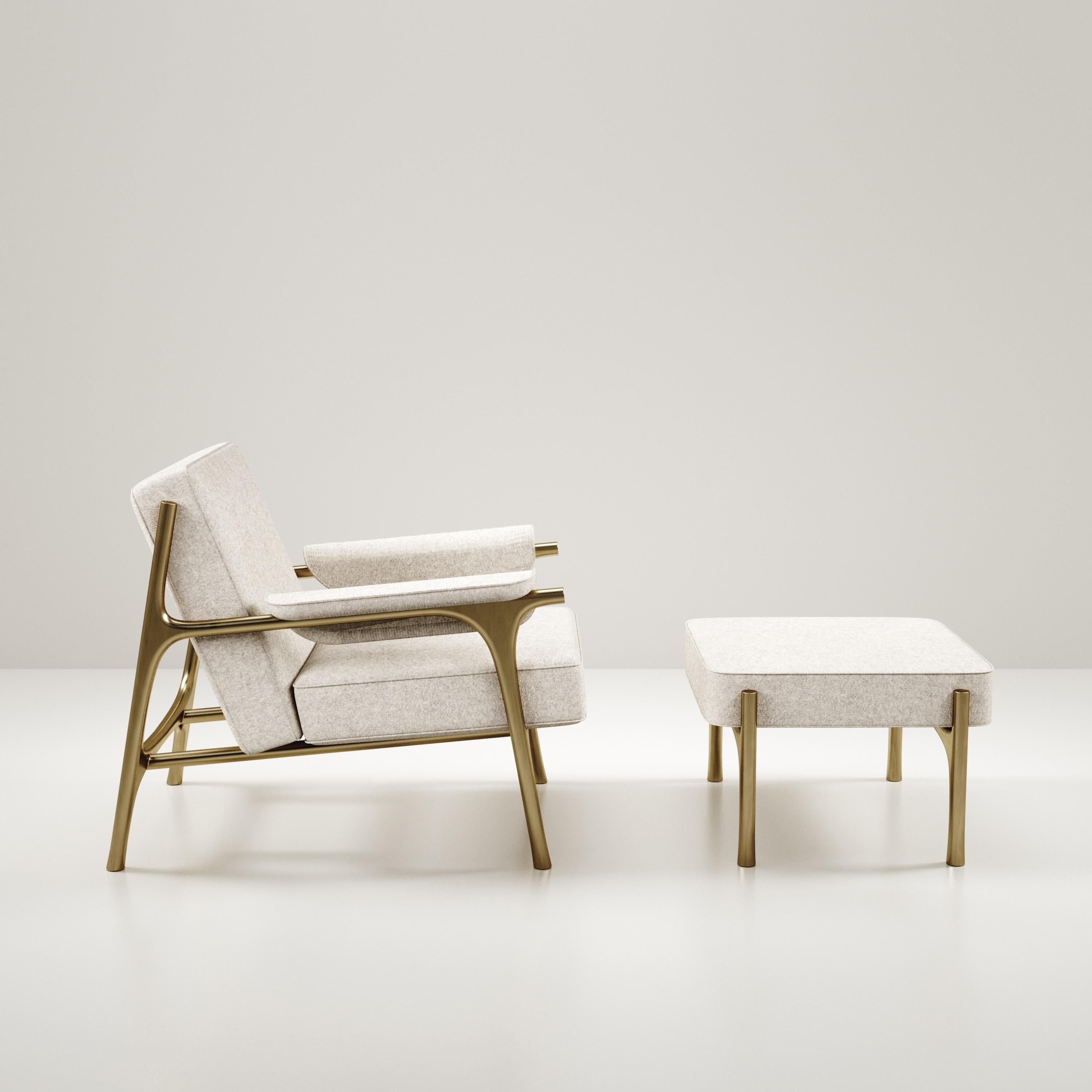 The Ramo armchair & footstool set by R & Y Augousti is an elegant and versatile piece. The upholstered pieces in cream Pierre Frey fabric provide comfort while retaining a unique aesthetic with the bronze-patina brass frame and details. This listing