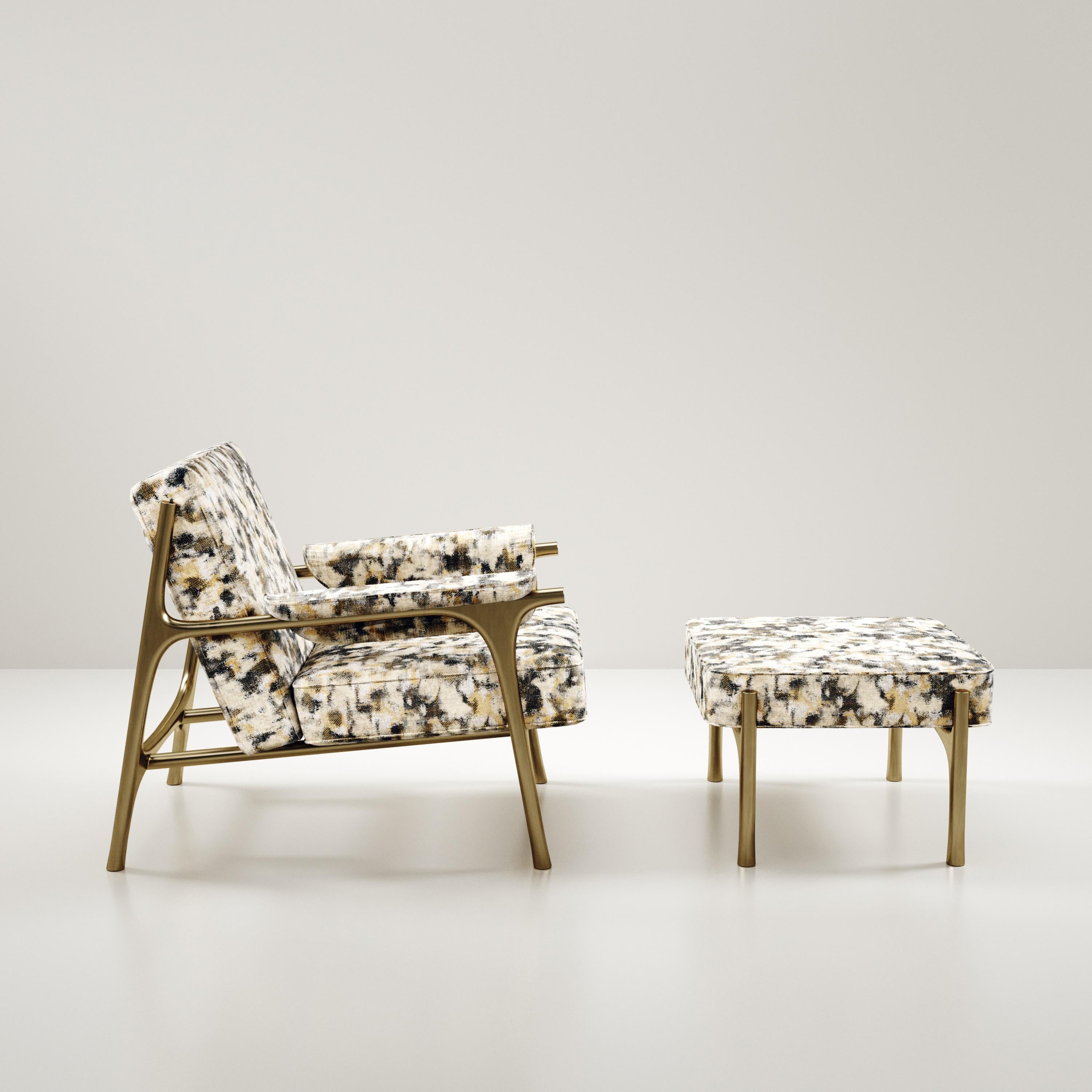 The Ramo Armchair & Footstool Set by R & Y Augousti is an elegant and versatile piece. The upholstered pieces in camouflage Pierre Frey fabric provide comfort while retaining a unique aesthetic with the bronze-patina brass frame and details. This