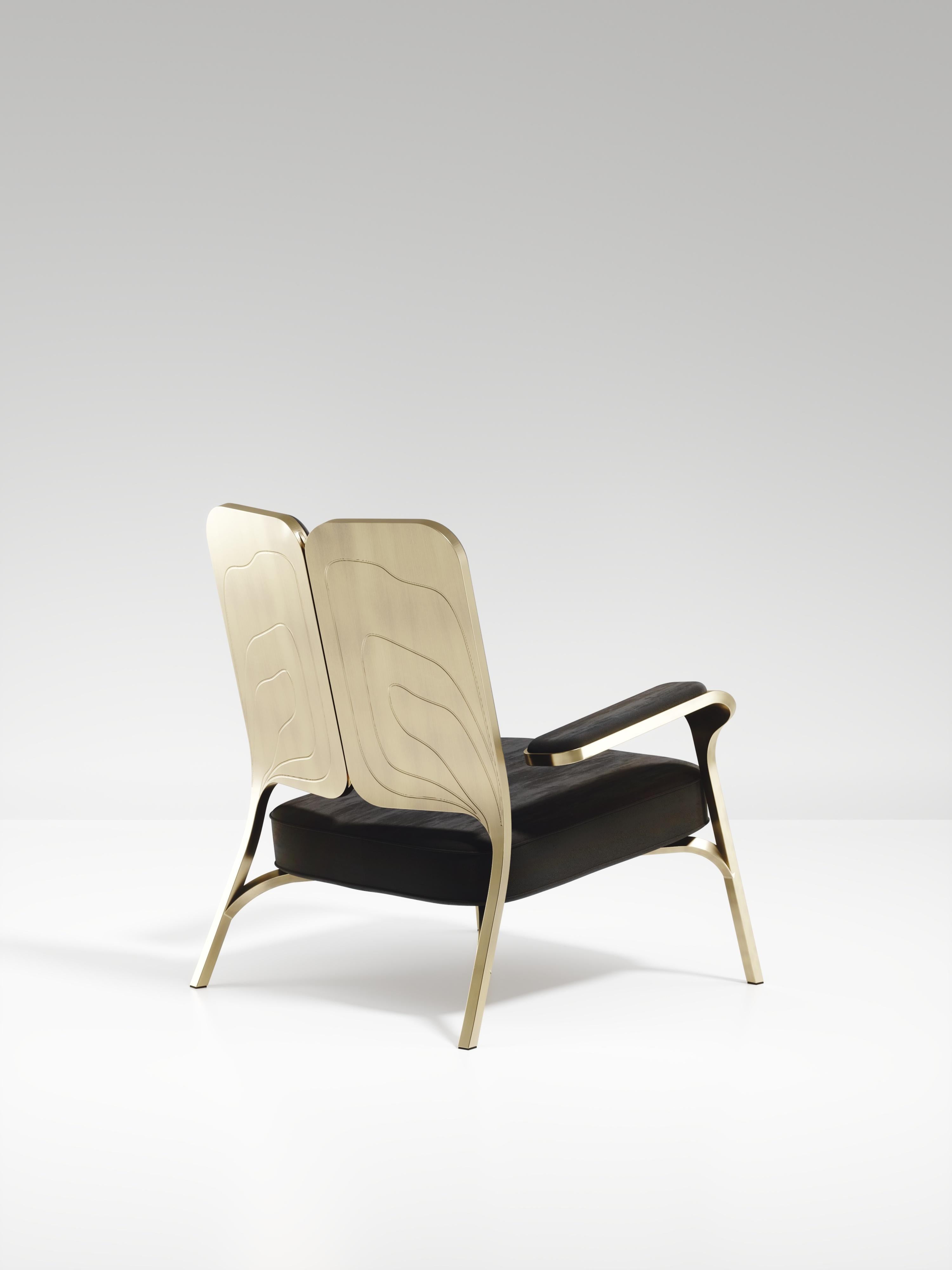 The Gingko armchair by R & Y Augousti is an elegant and whimsical piece. The black velvet upholstered piece provides comfort while exuding a playful aesthetic in its abstract nod to a butterfly with the form of its backrest and intricate engraving