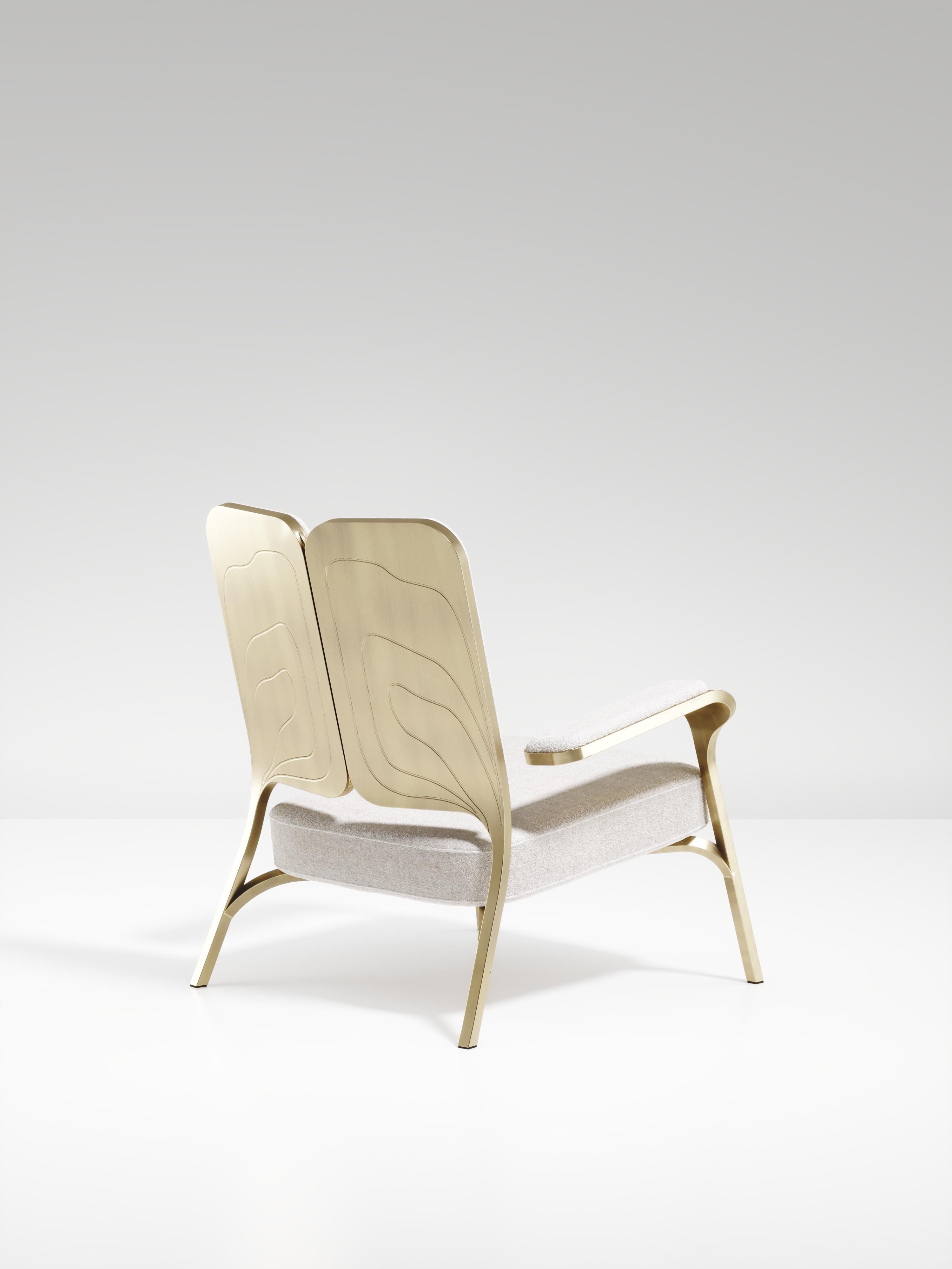 The Gingko armchair by R & Y Augousti is an elegant and whimsical piece. The cream linen upholstered piece provides comfort while exuding a playful aesthetic in its abstract nod to a butterfly with the form of its backrest and intricate engraving