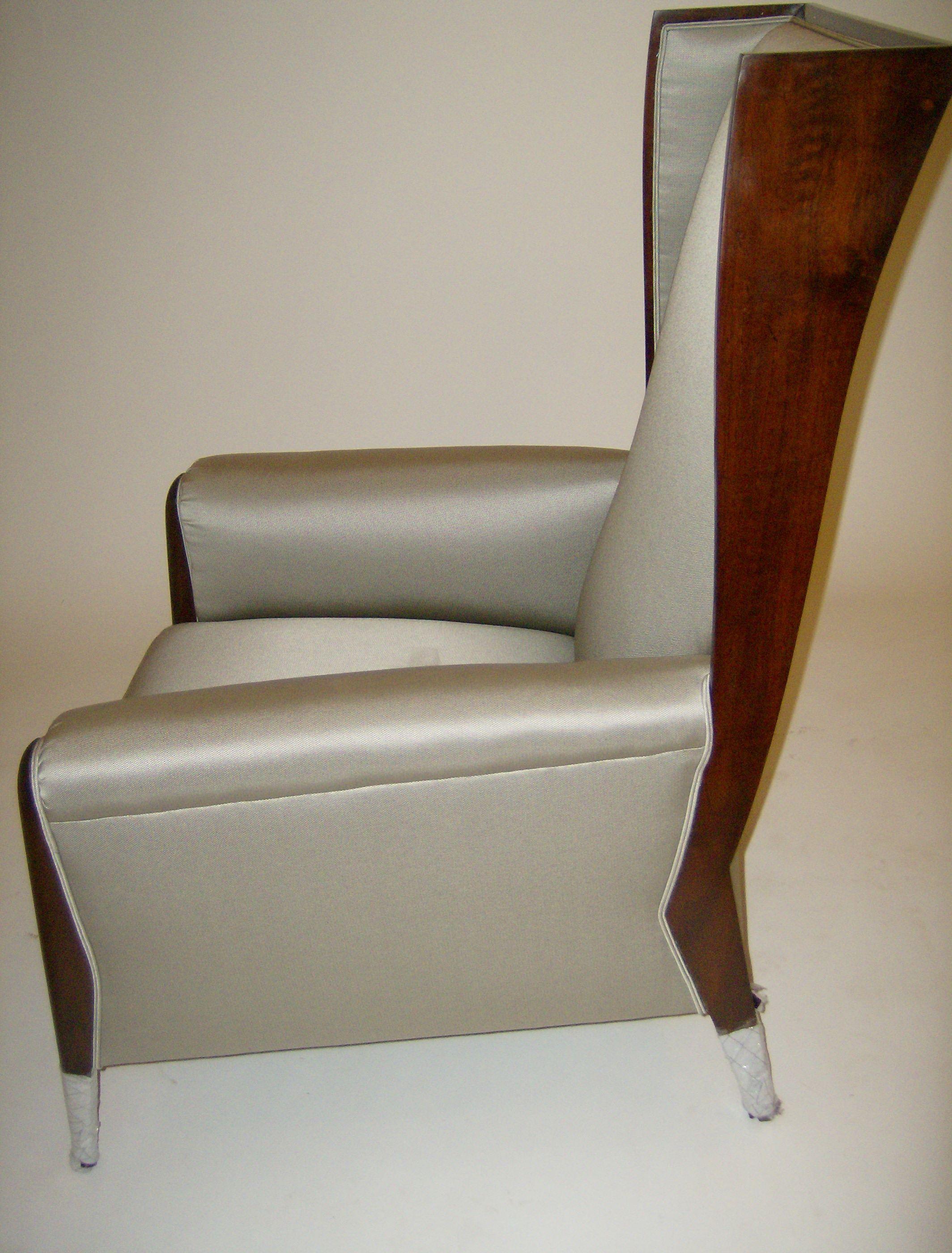 Upholstered Art Deco inspired wing chair in solid mahogany with custom upholstery option in your fabric COM/COL. Graceful design upholstered with tied springs and synthetic hoarse hair cushioning.