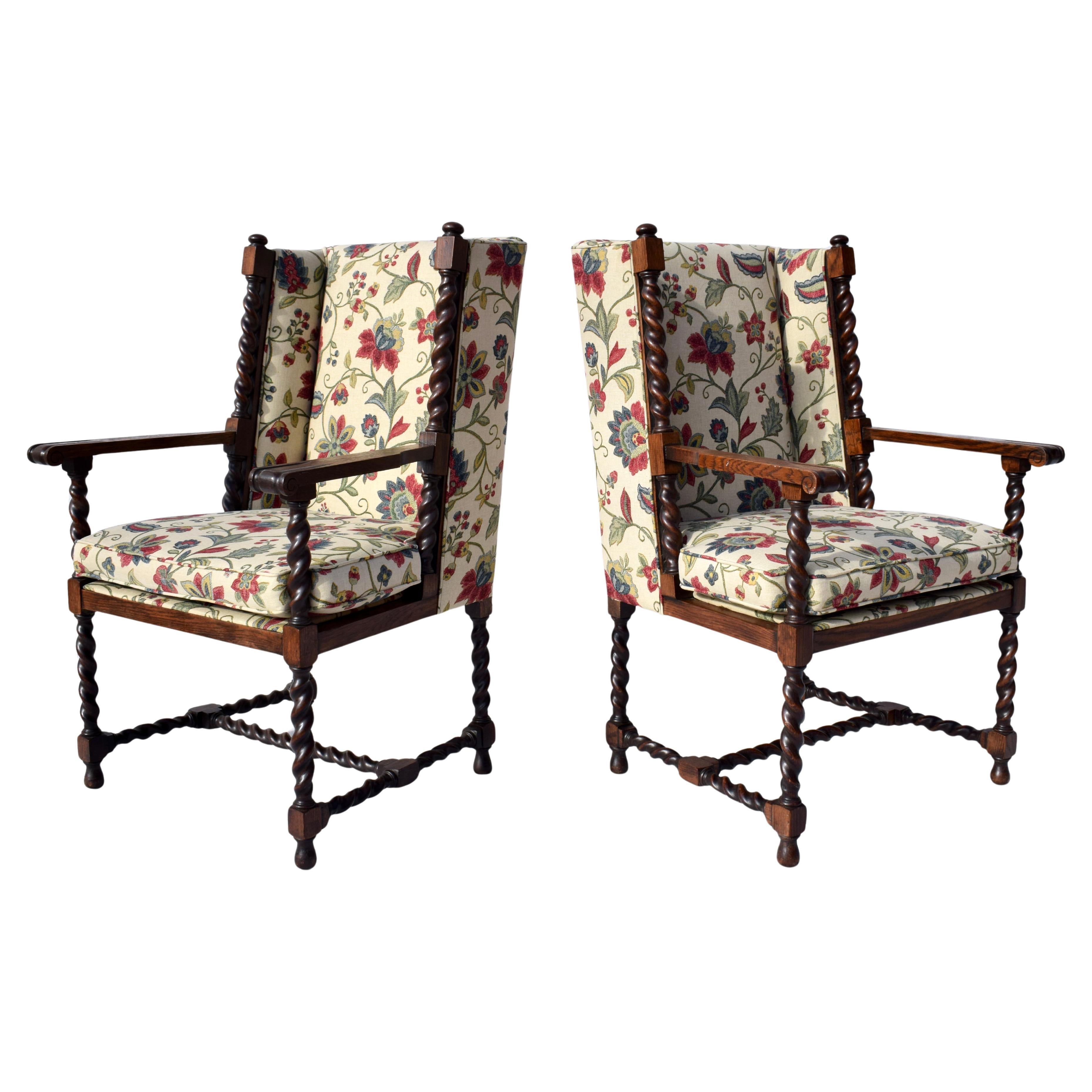 A pair of early 20th C. English Barley twist wing back chairs with original finish, new custom upholstery, loose cushions on the seats & H stretchers. Striking mid size silhouettes; fully restored. Seats:  21