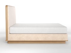 Upholstered Bed with Rounded Covered Headboard on Carved Wood Platform and Base