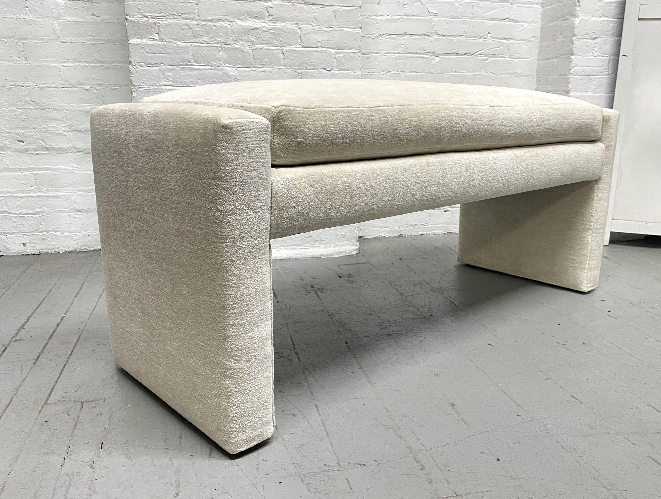 Upholstered bench by Directional. The bench has an off-white upholstery with a loose cushioned seat.