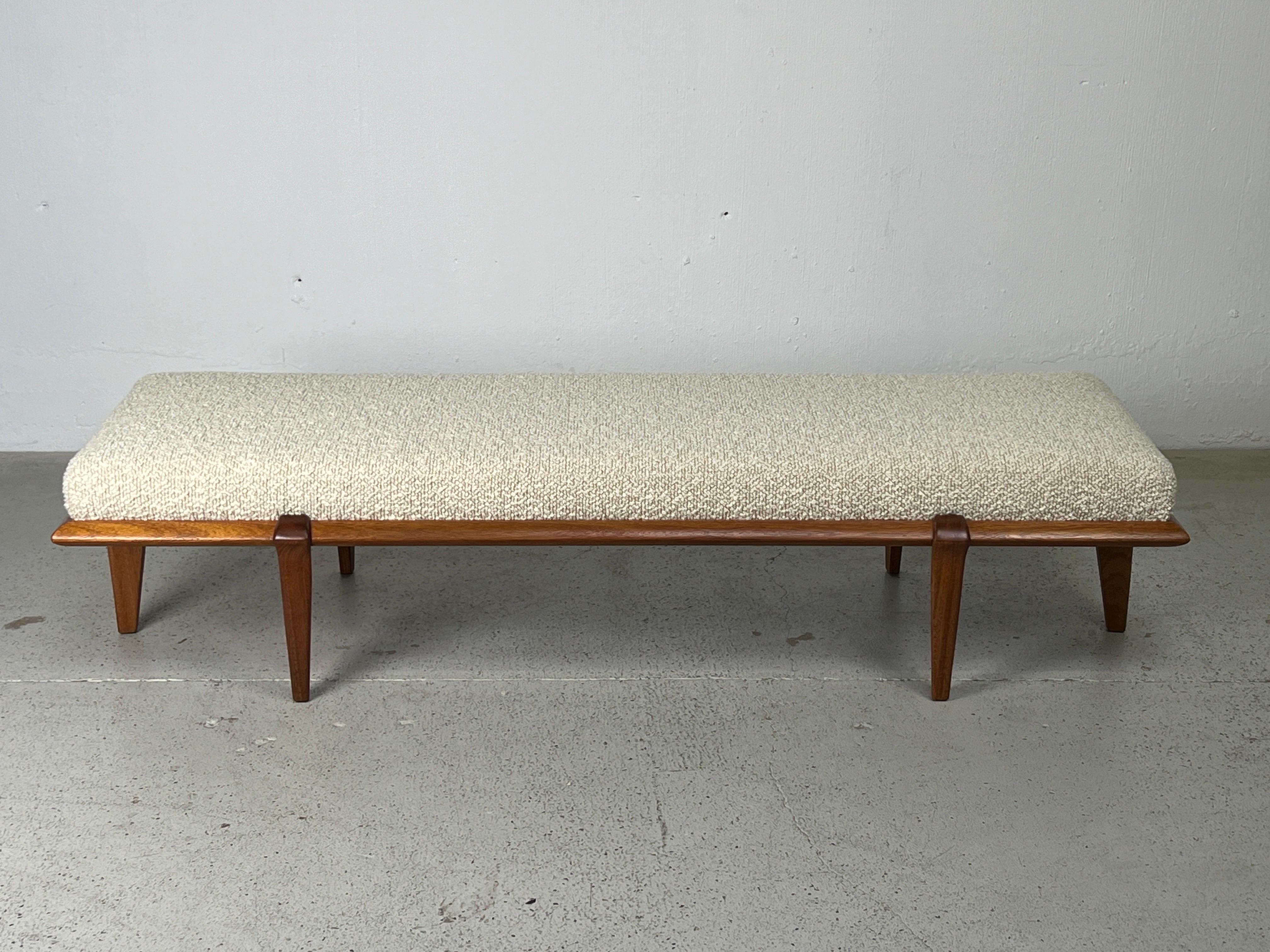 A sculpted mahogany bench with upholstered top. Designed by John Keal for Brown Saltman. 