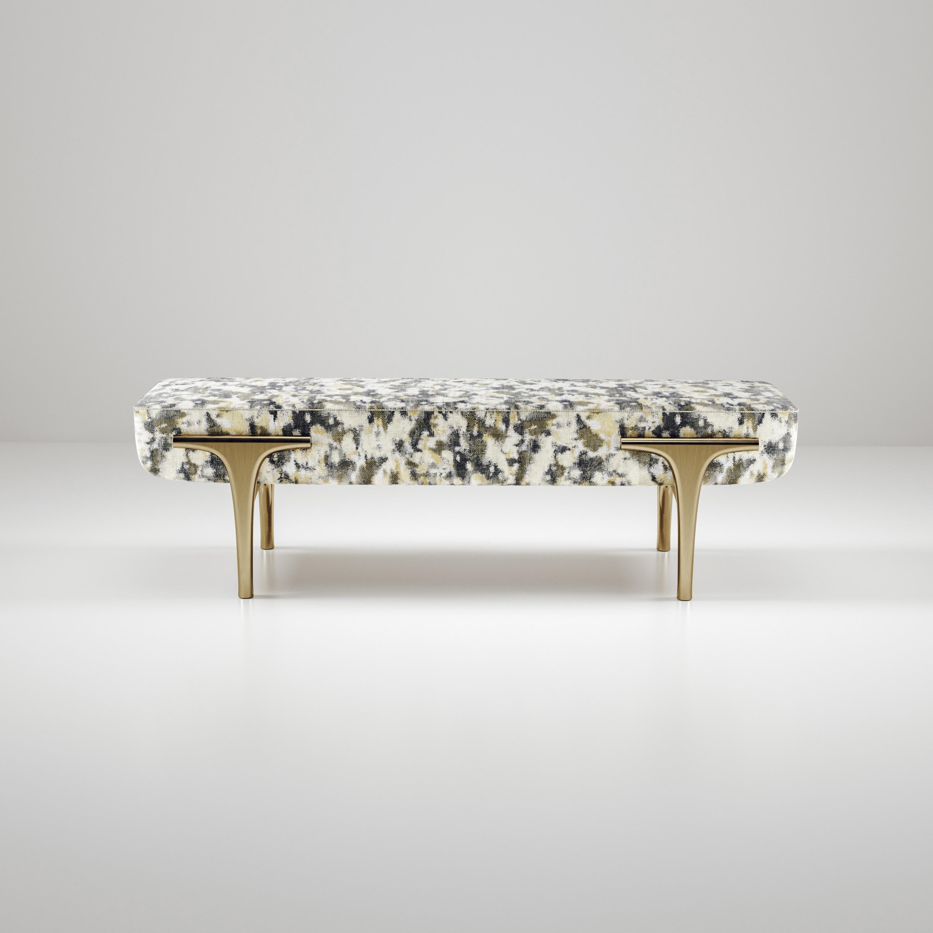 The Ramo Bench by R & Y Augousti is an elegant and versatile piece. The upholstered piece provides comfort while retaining a unique aesthetic with the bronze-patina brass frame and details. The camouflage pattern is a Pierre Frey fabric. This